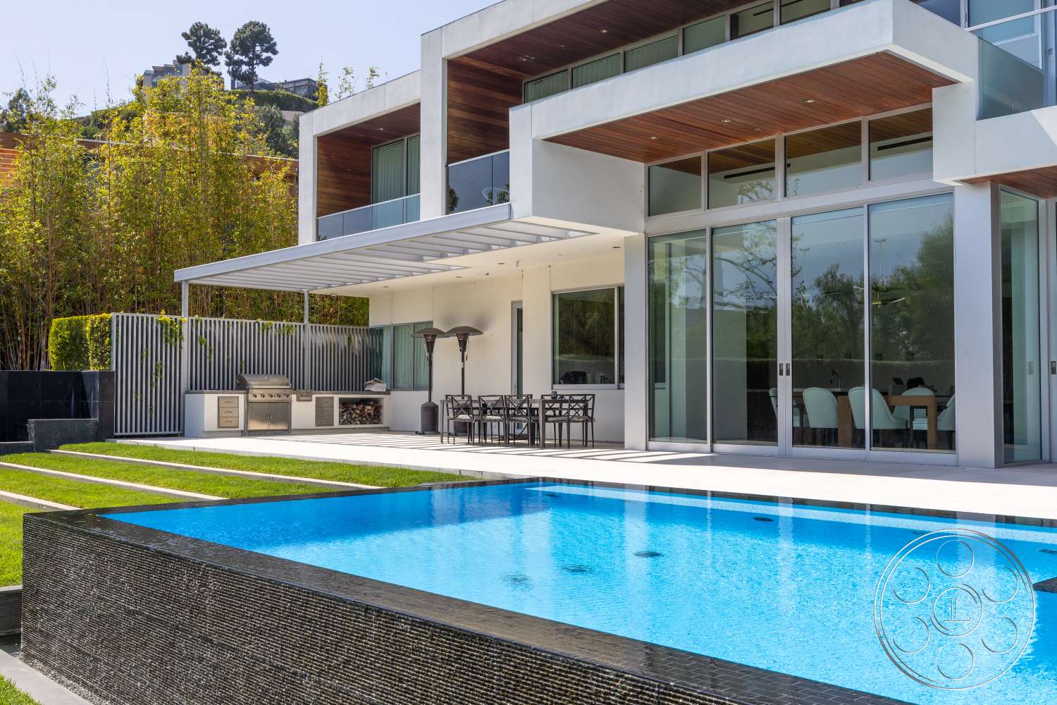 Modern 14 - natural light, modern architecture, minimalist design, open floor plan, glass sliding doors, urban setting, architectural details, floor-to-ceiling windows, outdoor dining area, lush landscaping, infinity pool, rectangular pool, poolside lounge area, sunny outdoor space, wood beam ceiling, concrete patio floor, luxury home exterior, stone pool border, stainless steel outdoor kitchen
