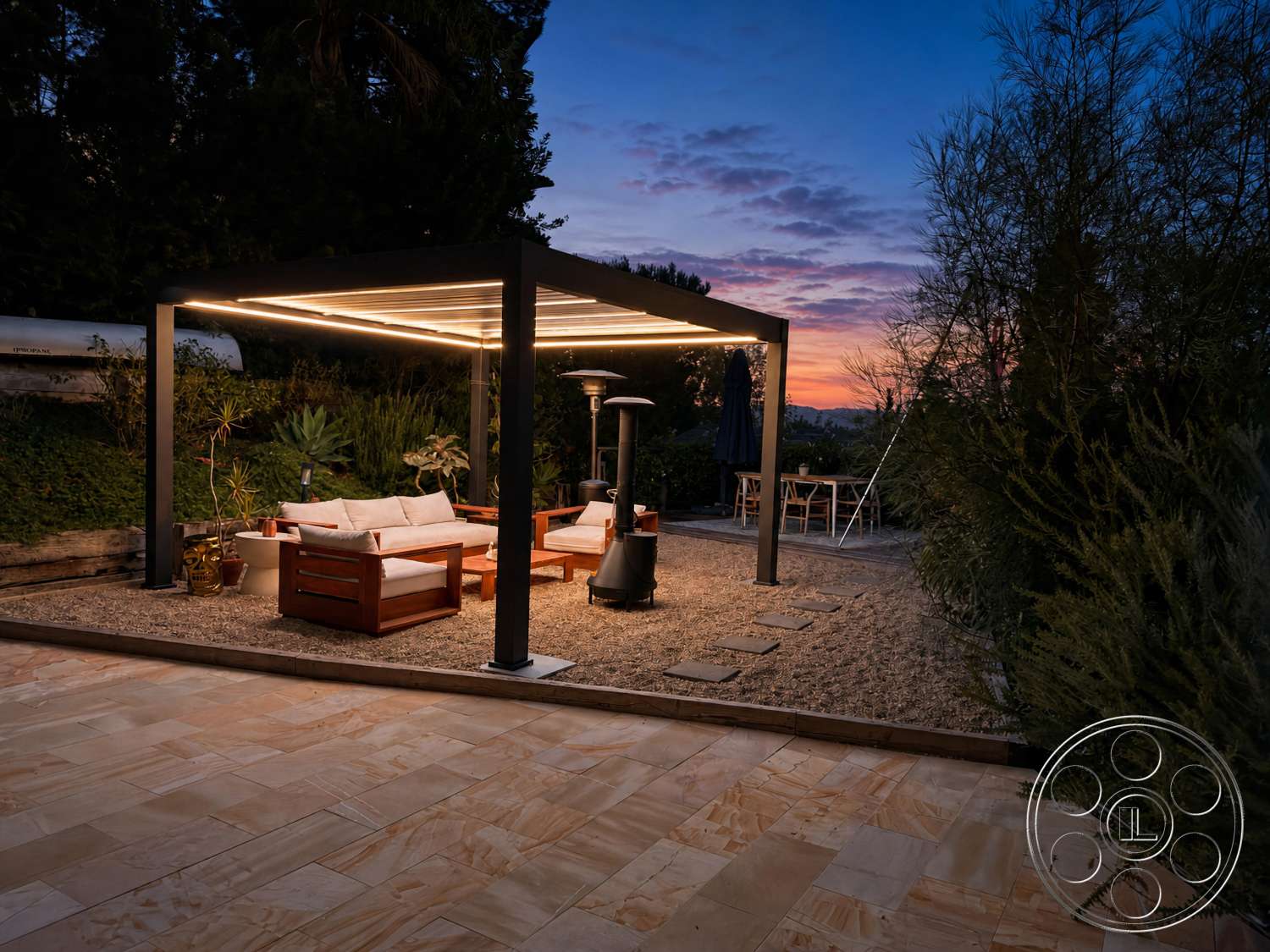 Americana 435 - exterior, potted plants, natural greenery, gravel pathway, sunset view, outdoor heating lamp, landscaped garden setting, rectangular seating arrangement, ambient LED lighting, metal pergola structure, modern outdoor dining table, wood outdoor seating area, concrete garden patio flooring