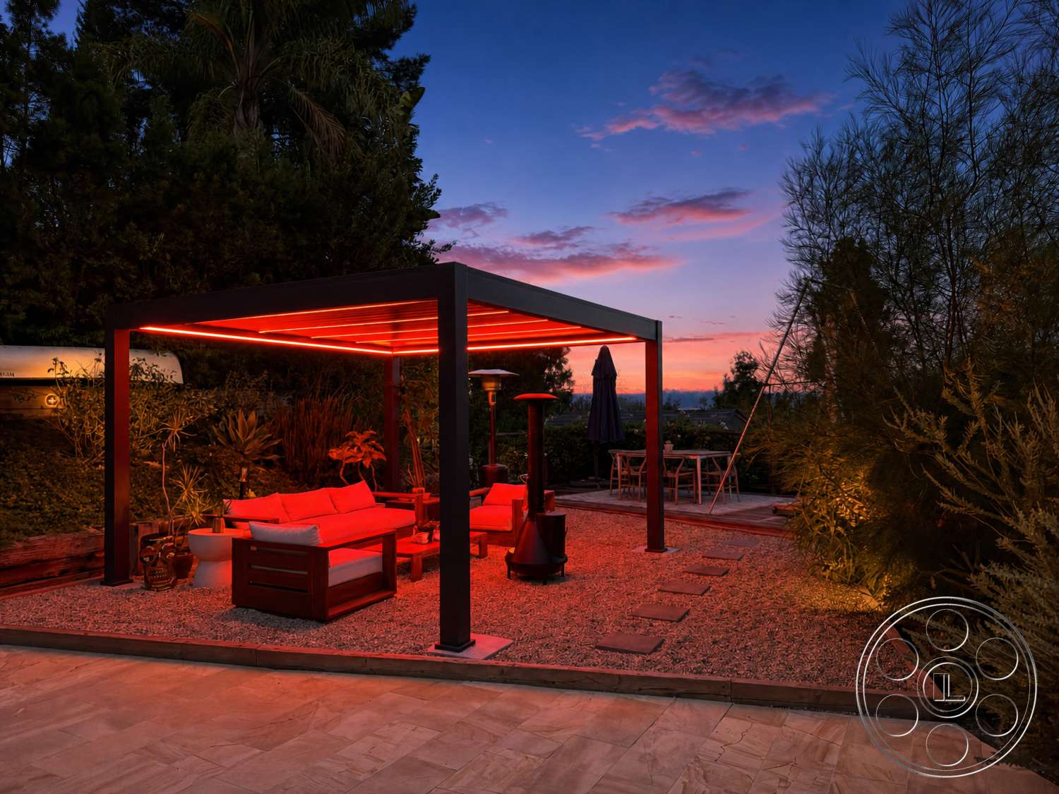 Americana 435 - exterior, wooden dining table, sunset view, gravel landscaping, backyard setting, umbrella, rectangular coffee table, garden plants, outdoor heater, concrete patio flooring, decorative stone accents, red LED lighting, metal patio gazebo, wood outdoor seating