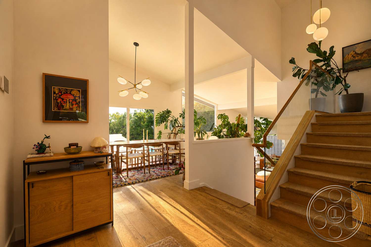 Americana 435 - large windows, indoor plants, open floor plan, modern light fixtures, natural wood flooring, wooden sideboard, wooden staircase, exposed wood beams, decorative wall art, textile area rug, drywall walls
