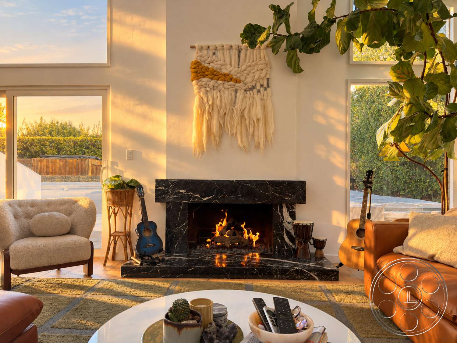 Americana 435 - natural light, indoor plant, acoustic guitar, hardwood floor, leather sofa, wooden side table, large floor-to-ceiling windows, plush area rug, decorative coffee table, modern armchair, drum, white painted walls, marble fireplace surround, woven wall art