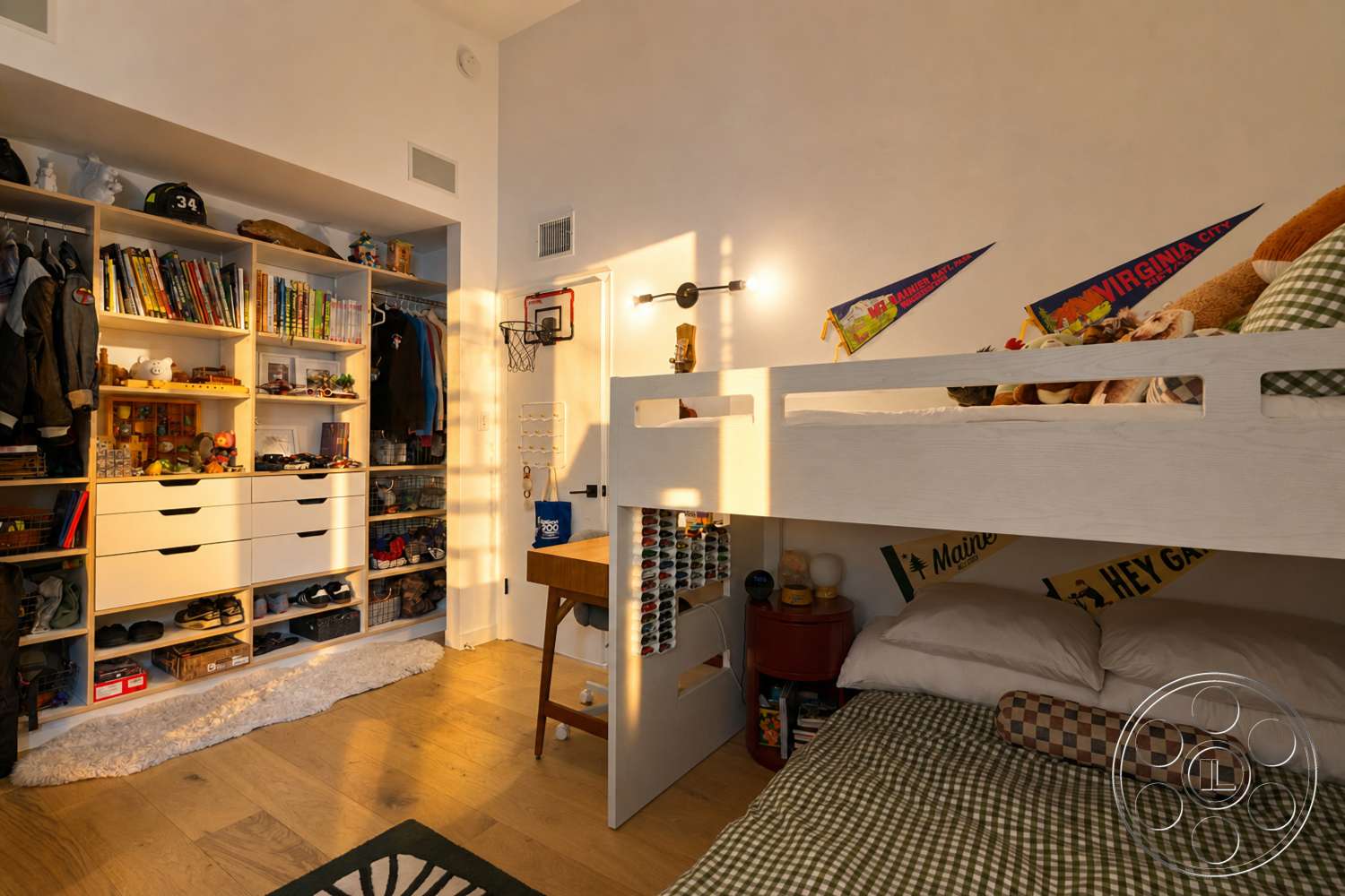 Americana 435 - hardwood bedroom floors, white painted walls, built-in storage shelving, bunk bed with wooden frame, desk with wood finish, rug on floor, decorative wall pennants, soft lighting from wall-mounted lamp