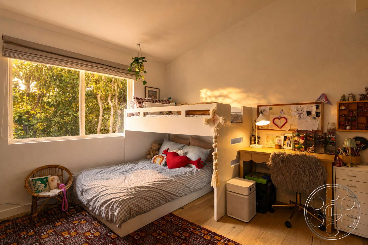 Americana 435 - woven area rug, woven basket chair, multicolored wall art, playful decor elements, large window with natural light, hardwood bedroom floors, white painted walls, bunk bed design, gray plaid bedding, wooden desk with storage, fluffy desk chair, indoor plant on window sill, decorative stuffed animal, elevated sleeping area