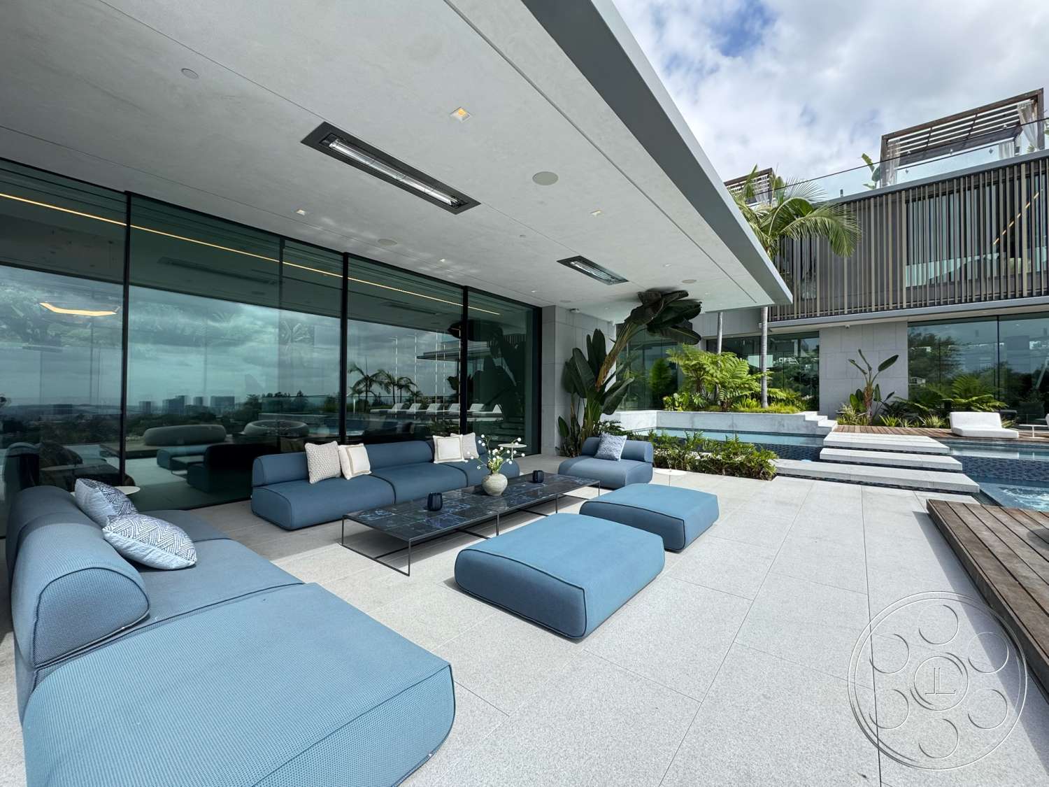 The Bellagio Estate - natural light, exterior, minimalist design elements, glass sliding doors, rectangular swimming pool, modern architectural style, open outdoor space, decorative potted plants, landscaped garden area, concrete patio flooring, flat roof overhang, steel and glass railing, modular outdoor seating, sweeping city skyline view
