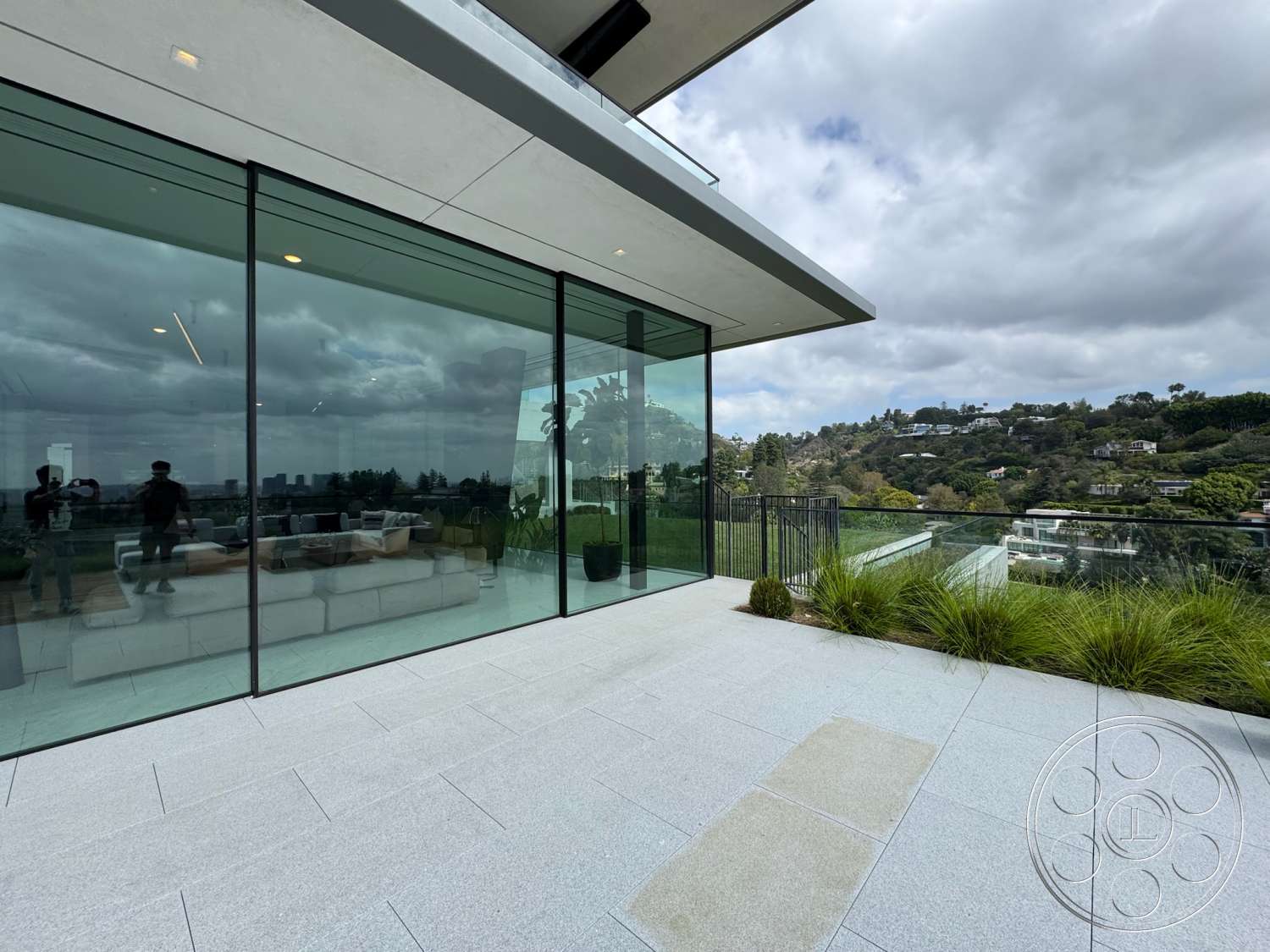 The Bellagio Estate - exterior, minimalist design elements, modern architectural style, open outdoor space, mountain view setting, stone patio flooring, greenery surrounding, landscaped outdoor area, glass wall facade, concrete roof overhang, rectangular terrace