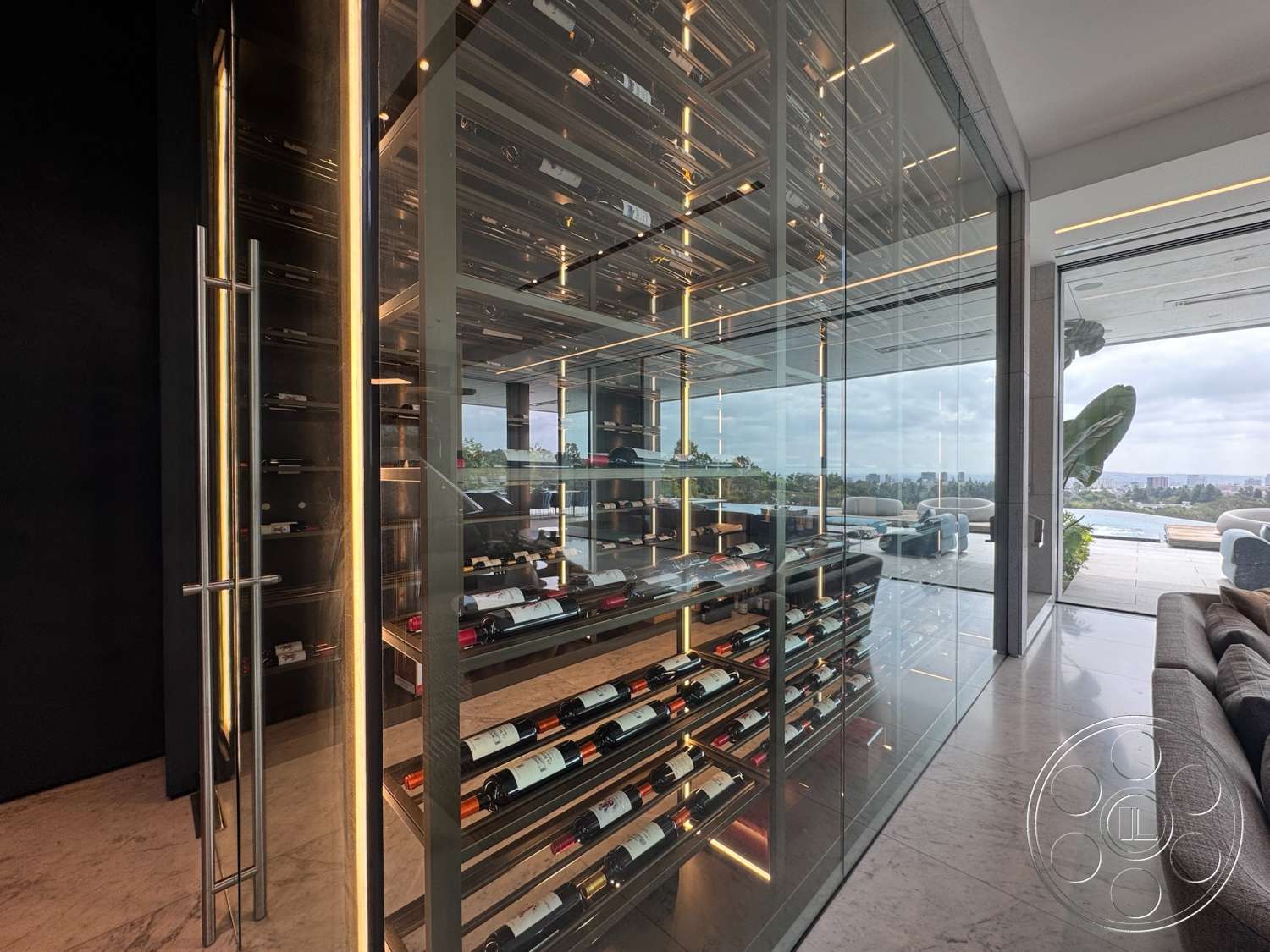 The Bellagio Estate - open floor plan, floor-to-ceiling windows, contemporary furnishings, under-cabinet lighting, modern architectural design, marble floor tiles, interior wine cellar, built-in wine rack, glass display walls, stainless steel frame