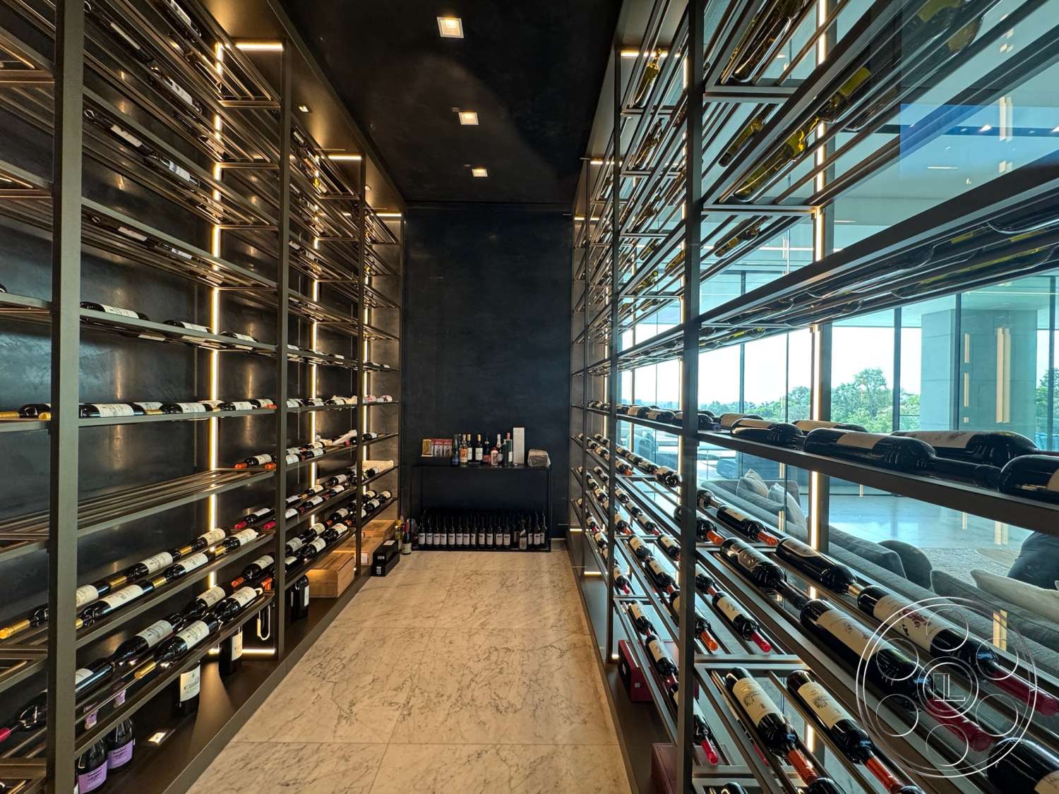 The Bellagio Estate - contemporary design, metal shelving, floor-to-ceiling windows, marble flooring, built-in cabinetry, ambient LED lighting, modern wine cellar, glass wine racks, dark plaster walls