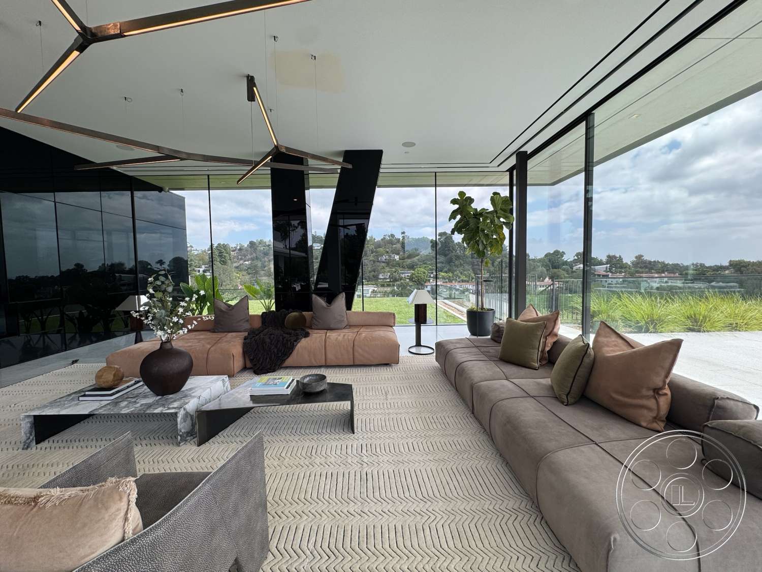 The Bellagio Estate - textured area rug, open floor plan, concrete flooring, floor-to-ceiling windows, marble coffee table, exposed ceiling, plush throw pillows, scenic outdoor view, low-profile sectional sofa, modern minimalist design, indoor potted plants, glass wall panels, metallic light fixtures