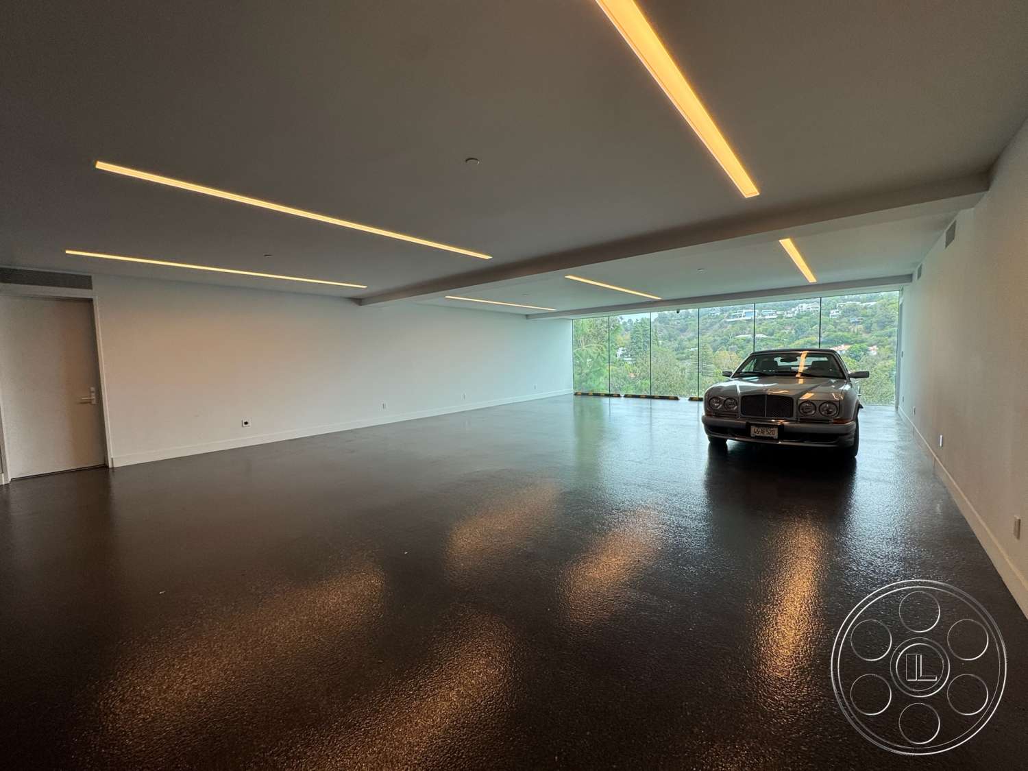 The Bellagio Estate - polished concrete flooring, floor-to-ceiling windows, contemporary architecture, modern minimalist design, spacious open layout, linear recessed lighting, rectangular room layout, textured white plaster walls, indoor garage space