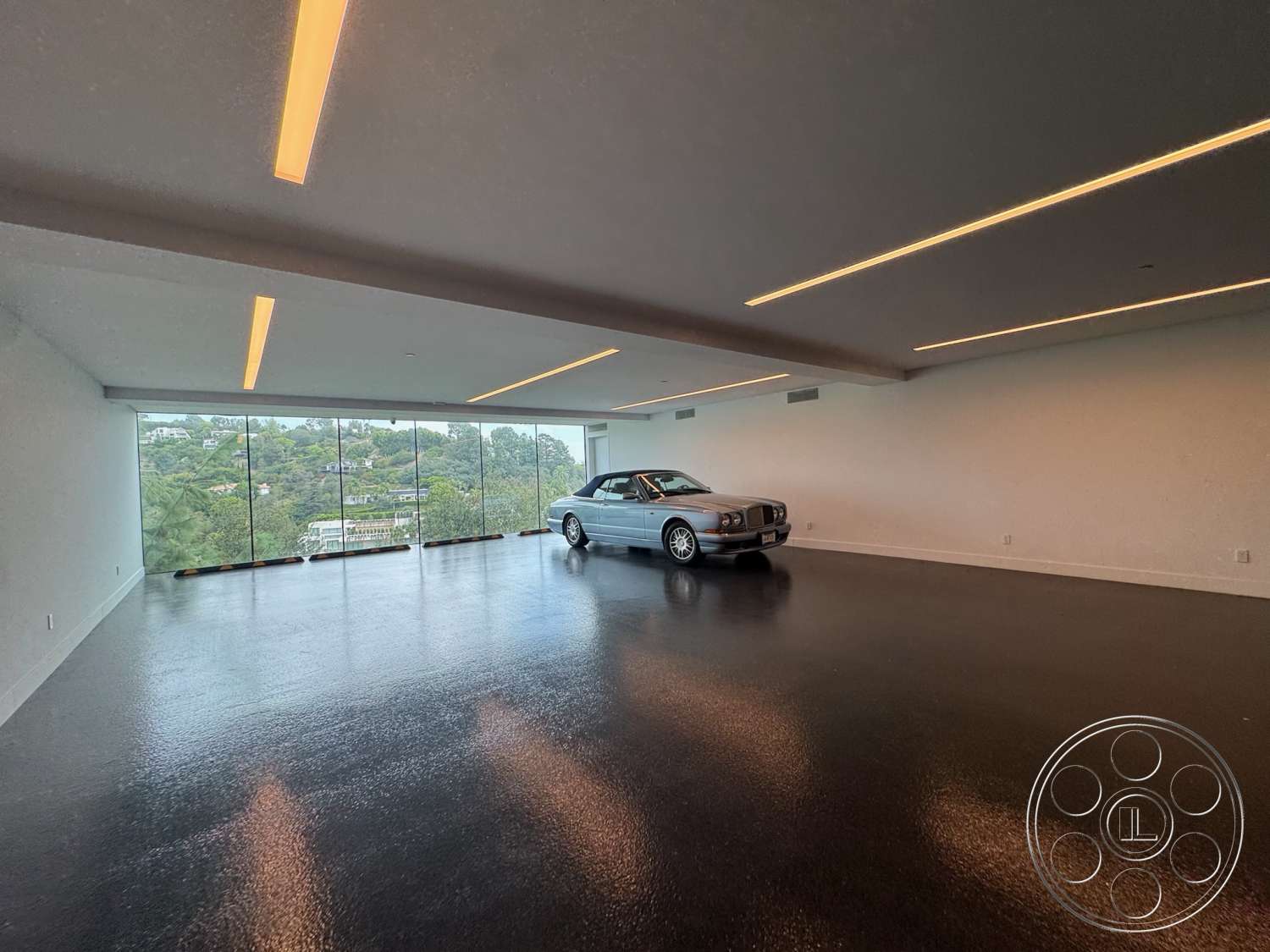 The Bellagio Estate - polished concrete flooring, open space layout, modern aesthetic, smooth white walls, floor-to-ceiling glass windows, minimalist architectural style, recessed LED lighting