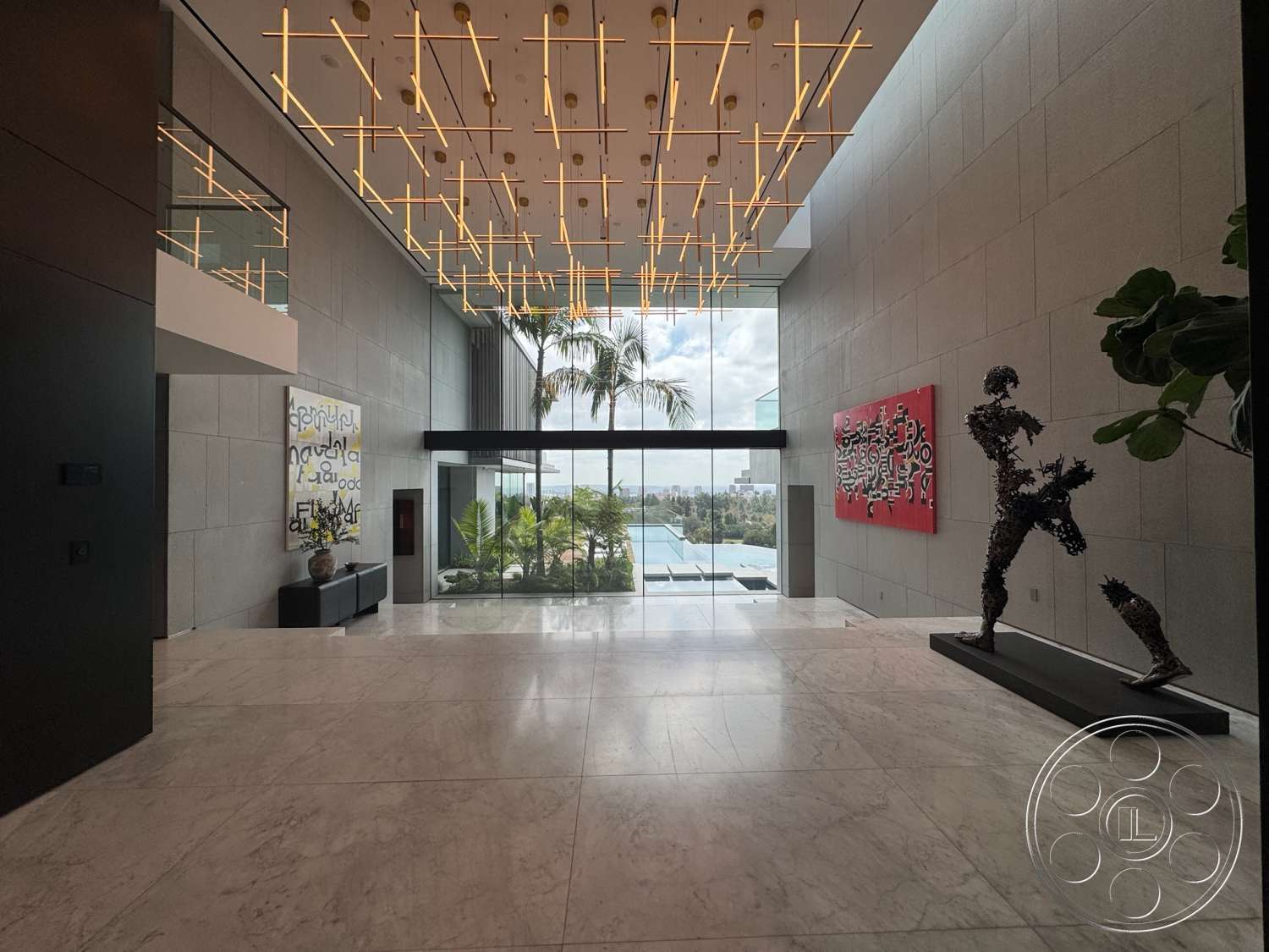The Bellagio Estate - textured wall art, modern lighting fixtures, exposed concrete walls, contemporary design elements, marble flooring, floor-to-ceiling glass windows, potted indoor plants, rectangular open layout, sculptural artwork