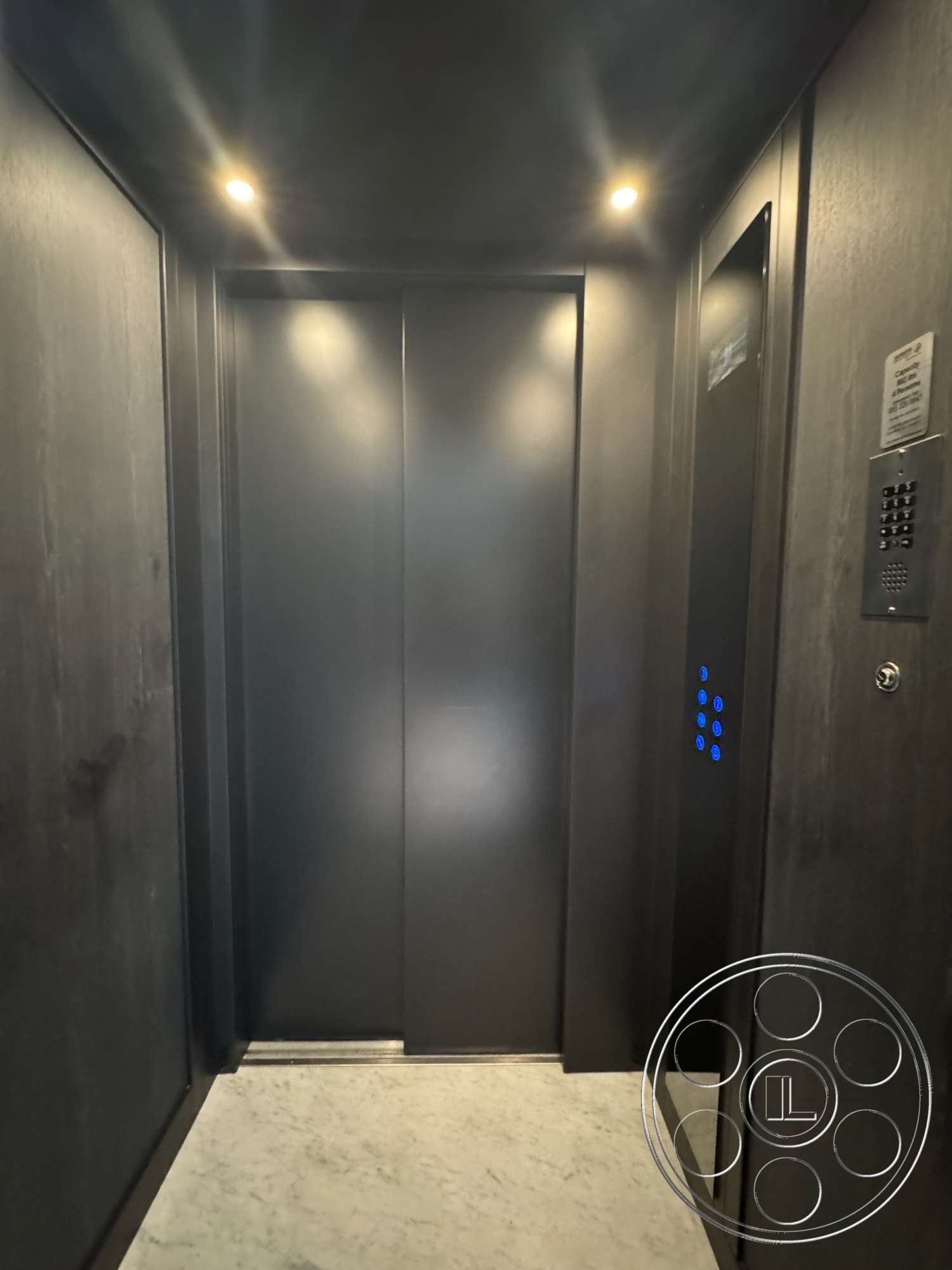The Bellagio Estate - minimalist design elements, marble flooring, flush ceiling lights, metal elevator doors, interior elevator, black laminate wall panels, glass mirror panel, blue LED button panel