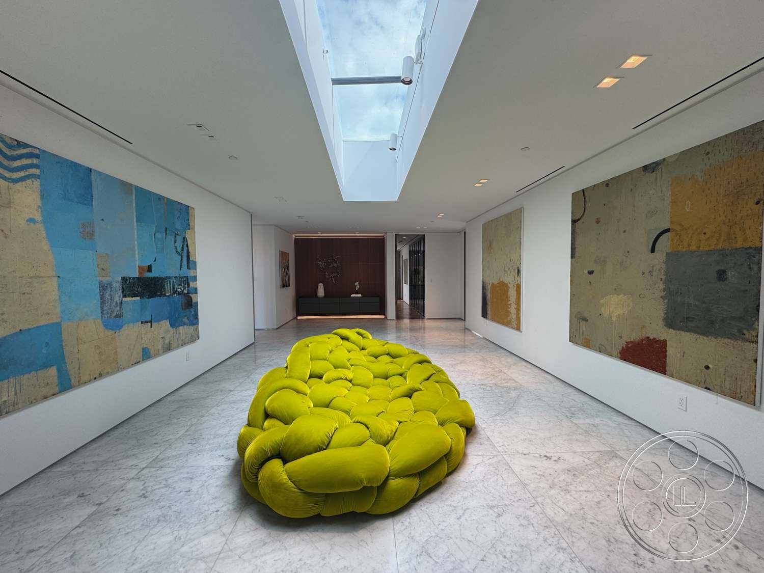 The Bellagio Estate - minimalist design, open floor plan, marble flooring, contemporary art on walls, modern architectural details, dimensional lighting fixtures, textured white walls, large skylight, focal point green upholstered seating