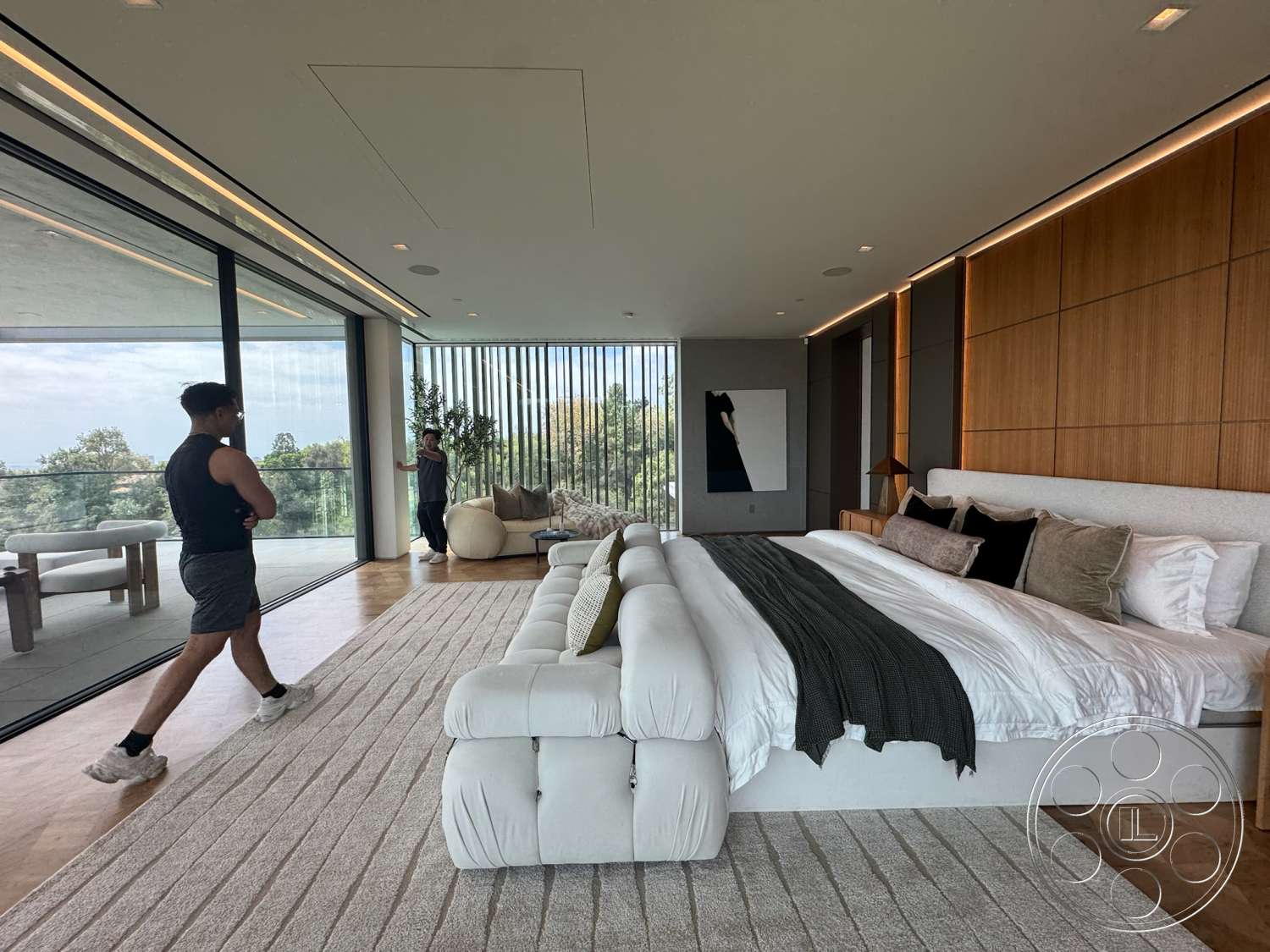 The Bellagio Estate - spacious layout, indoor plants, decorative pillows, floor-to-ceiling windows, neutral area rug, textured plaster ceiling, gray throw blanket, modern art decor, plush white bedding, minimalist furniture design, wood panel accent wall, oak hardwood flooring, luxury king-sized bed, view of landscaped greenery