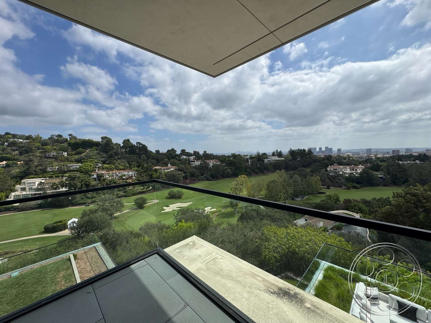 The Bellagio Estate - exterior, lush greenery, landscaped garden view, modern architectural style, city skyline view, open-air terrace, flat roof design, glass balcony railing, concrete balcony flooring, panoramic hillside setting