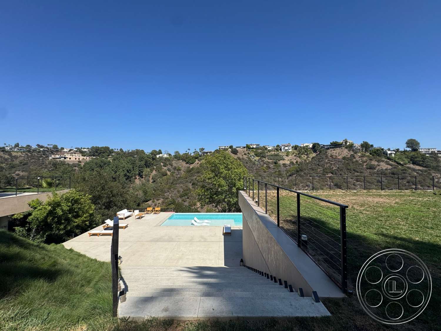 Modern 527 - exterior, glass railings, rectangular swimming pool, modern architectural style, concrete pool deck, hillside location, grass landscaping, concrete steps leading to pool area
