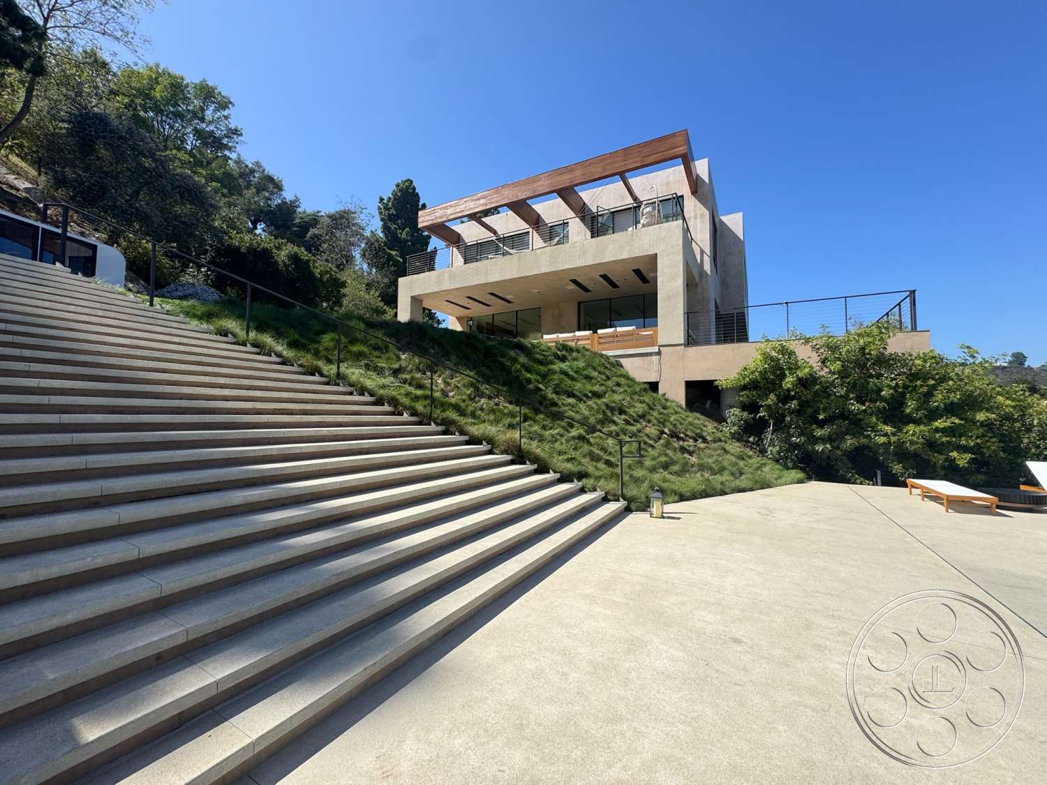 Modern 527 - exterior, modern architecture, large glass windows, green landscaping, concrete steps, two-story home, flat roof design, concrete patio flooring, wood slatted roof overhang