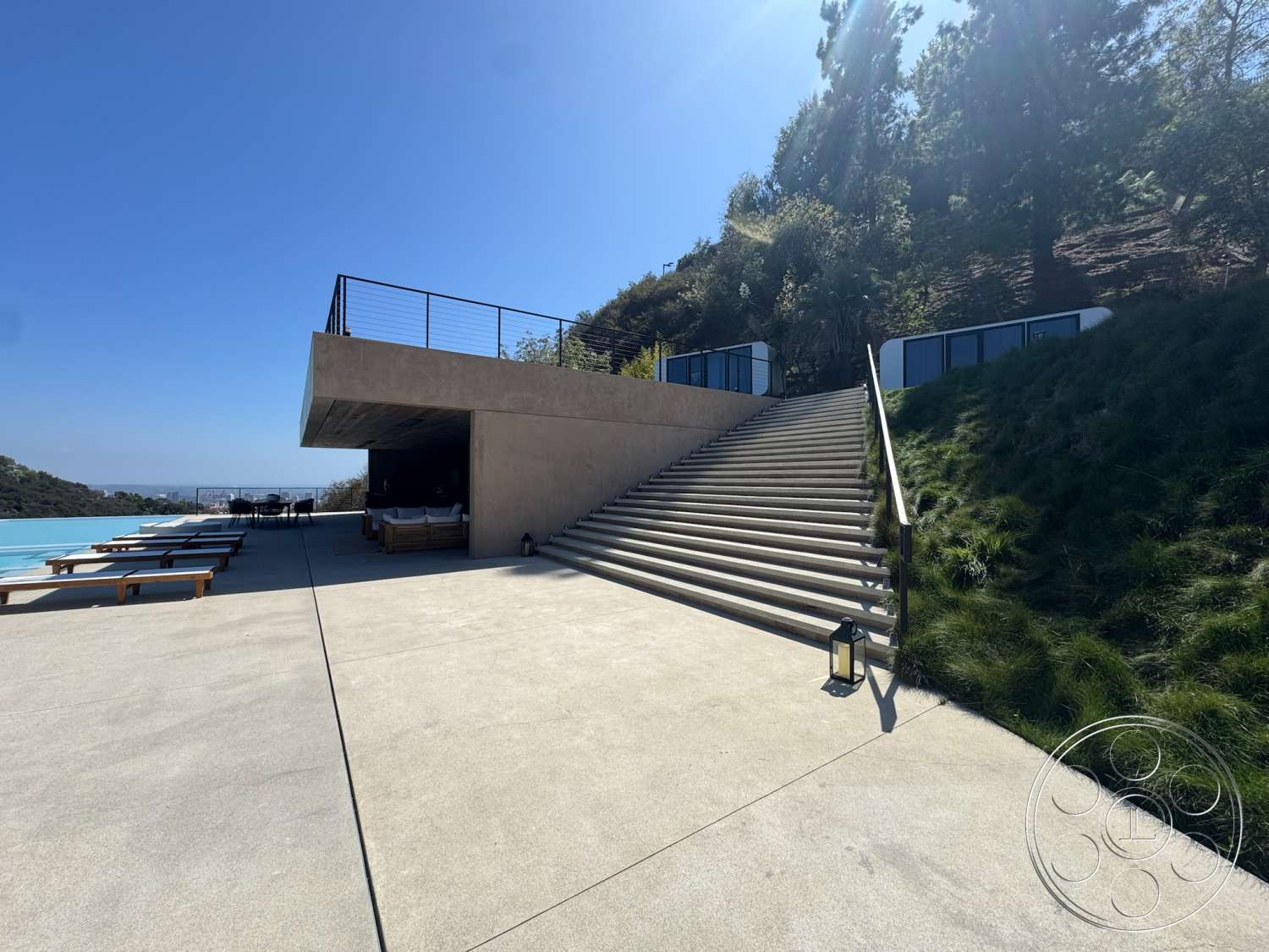 Modern 527 - glass railing, floor-to-ceiling windows, concrete steps, outdoor lounge area, modern architectural style, landscaped hillside, rectangular pool, urban hillside location, concrete patio flooring, concrete exterior walls, exposed concrete structure, bright sunlight setting