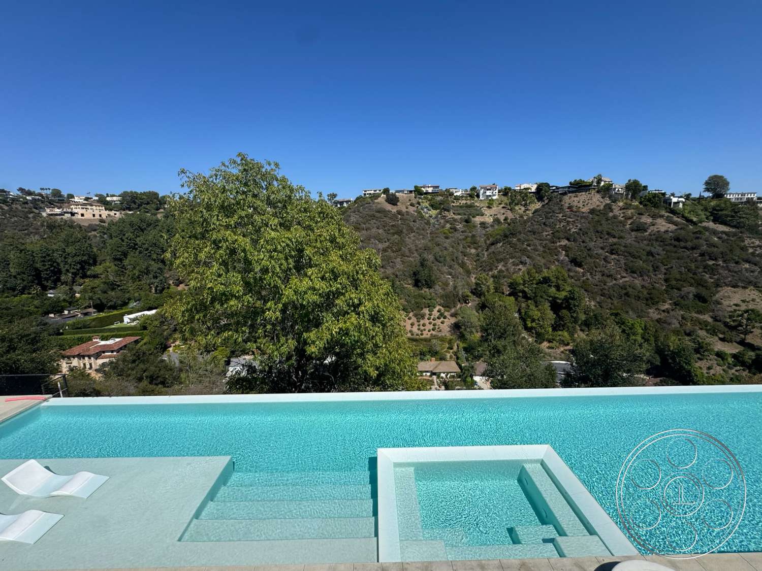 Modern 527 - exterior, water feature, modern architectural style, spa area, landscaped hillside, clear blue water, infinity pool, concrete pool deck, rectangular pool, surrounding hillside view