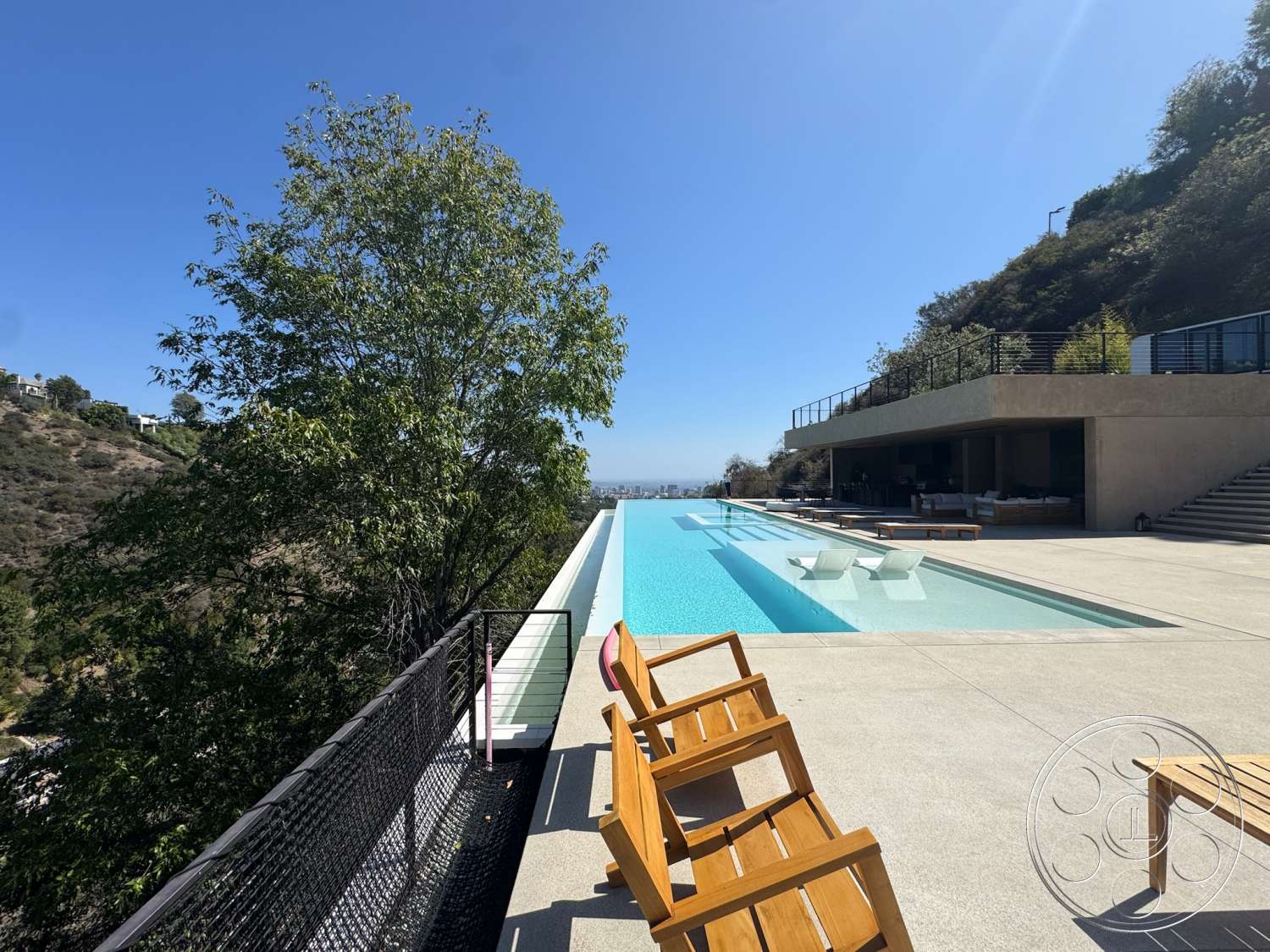 Modern 527 - minimalist design, landscape view, modern architectural style, infinity pool, concrete pool deck, wooden lounge chairs, outdoor entertainment area, concrete patio flooring, open outdoor living space, exposed hillside setting, floor-to-ceiling glass railings, concrete construction