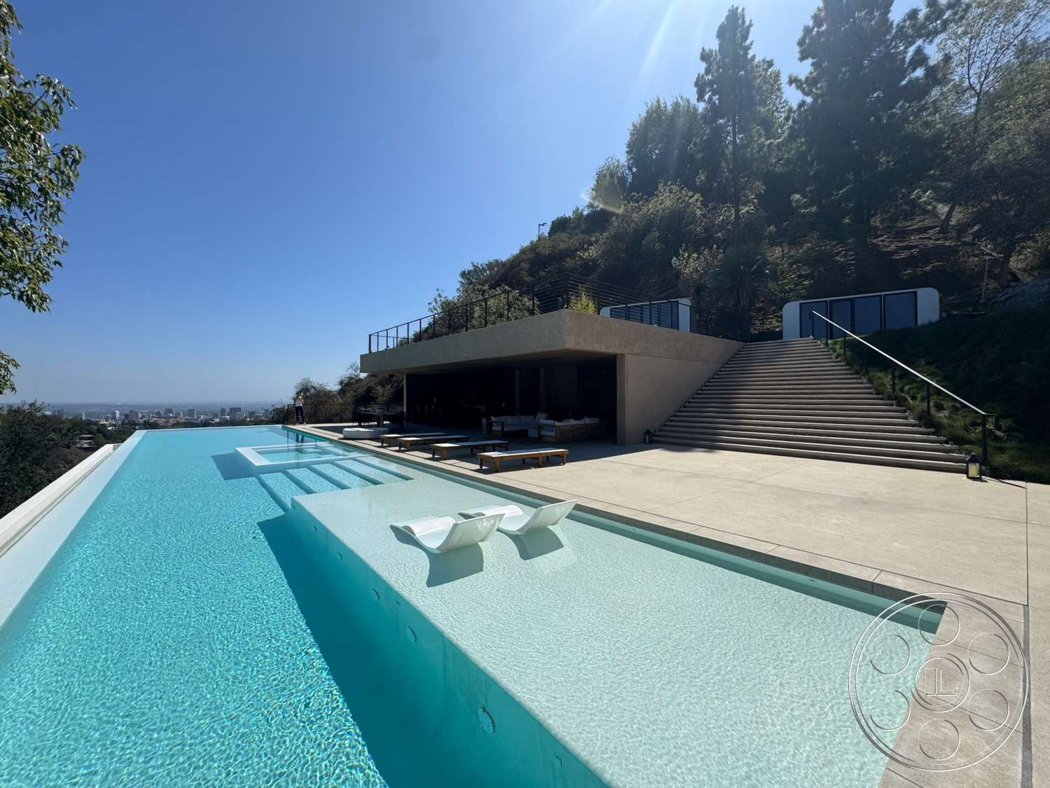 Modern 527 - exterior, landscaped garden, glass railing, modern outdoor furniture, sloped terrain, surrounding hillside, floor-to-ceiling windows, infinity pool, rectangular pool, minimalist architecture, concrete patio flooring, stucco exterior wall, large outdoor steps