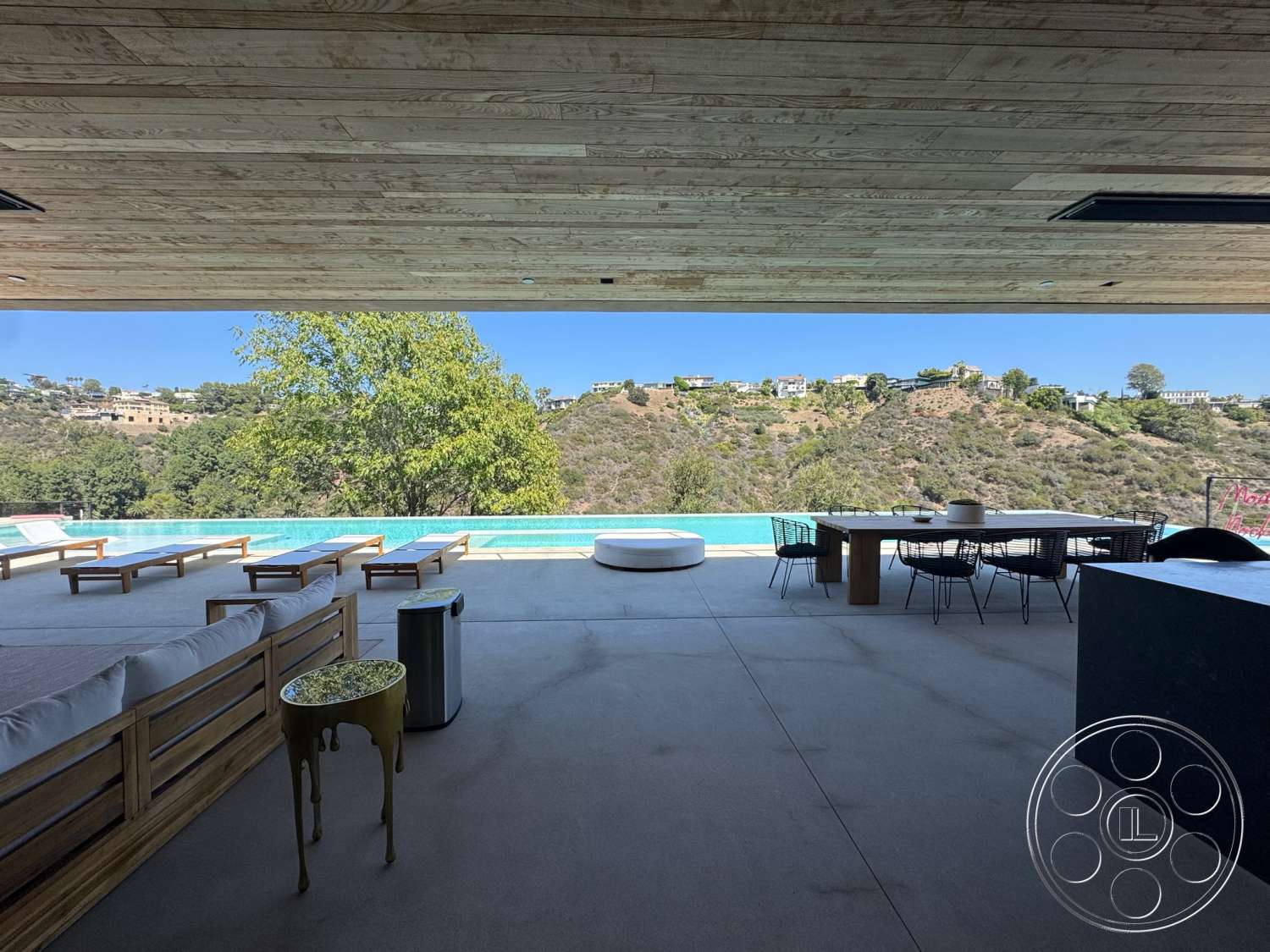 Modern 527 - exterior, glass railing, outdoor lounge area, wood ceiling panels, infinity pool, modern dining table, mountain view setting, concrete patio flooring, minimalist outdoor furniture, landscaped outdoor space