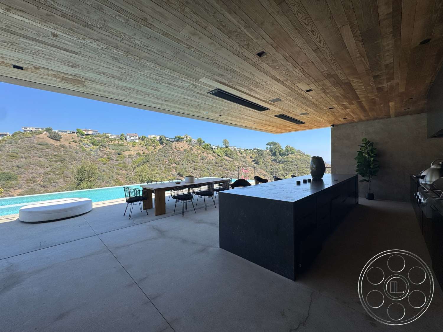 Modern 527 - exterior, floor-to-ceiling windows, modern architectural style, infinity pool, concrete kitchen island, metal dining chairs, mountain view setting, concrete patio flooring, wood plank ceiling, rectangle dining table