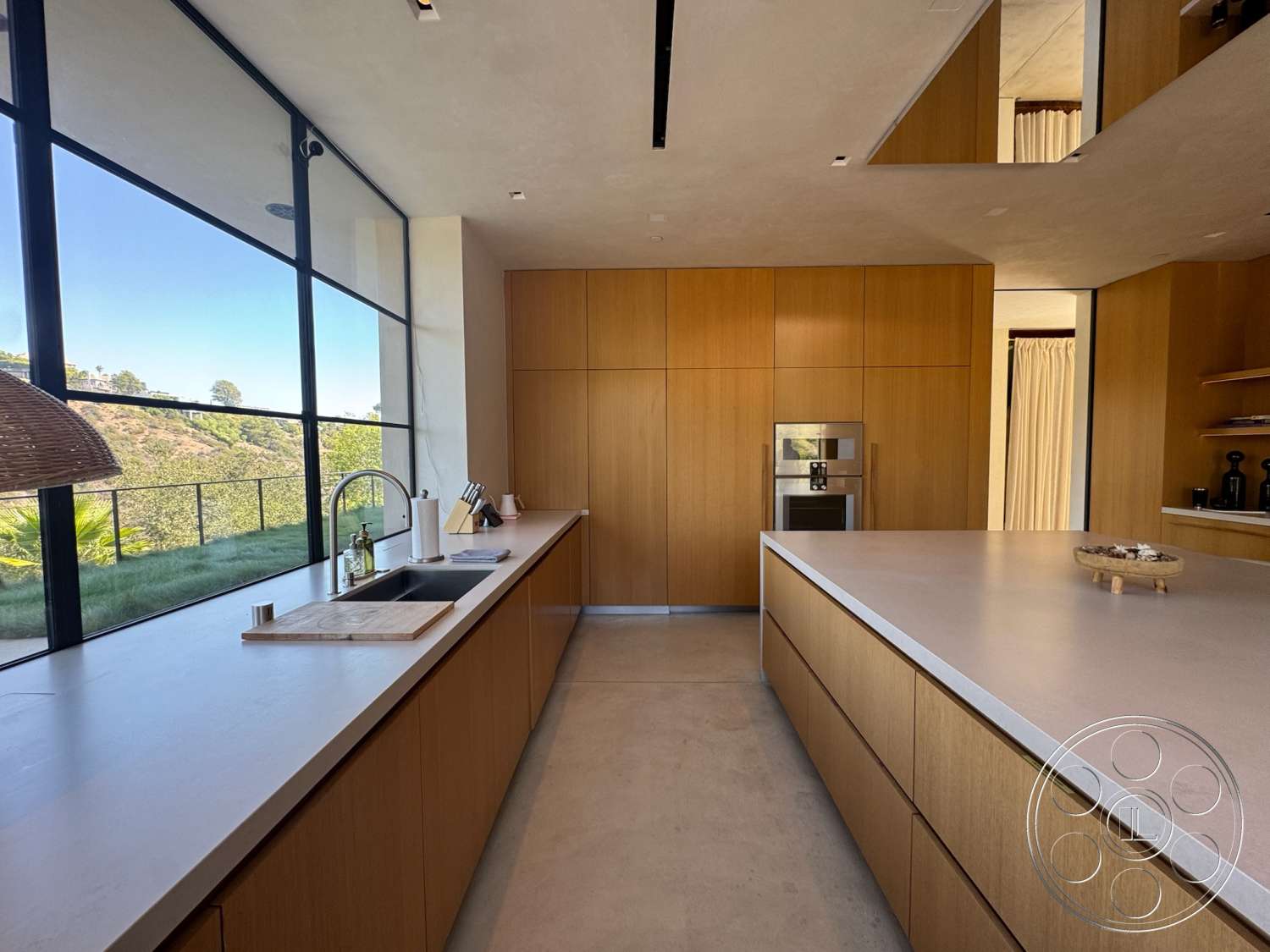Modern 527 - wood cabinetry, floor-to-ceiling windows, modern kitchen design, open concept kitchen, white quartz kitchen countertops, minimalist kitchen style, concrete kitchen flooring, light wood kitchen cabinets