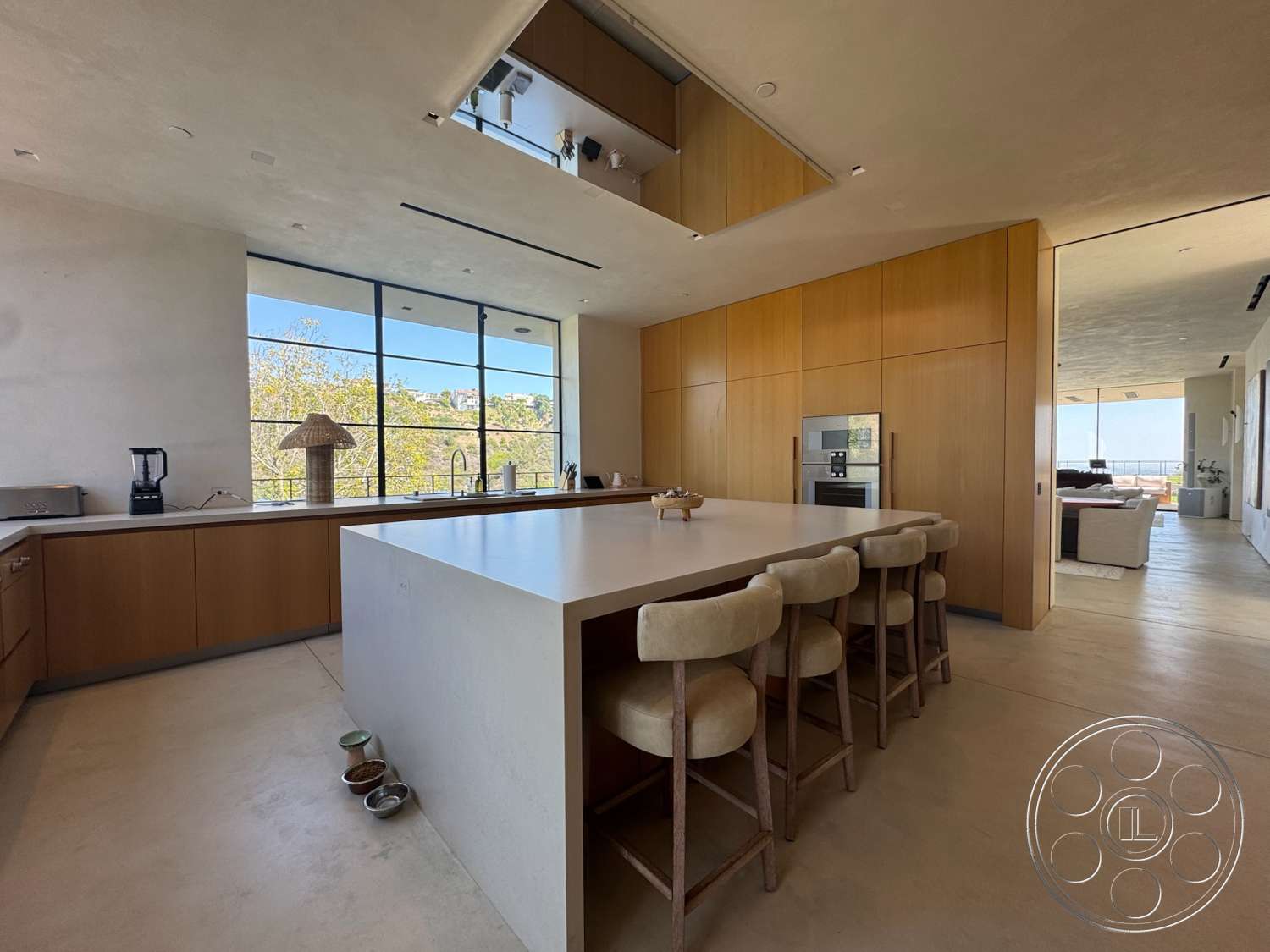 Modern 527 - floor-to-ceiling windows, open concept living space, concrete kitchen island, natural light interior, minimalist kitchen design, smooth plaster walls, exposed ceiling details, light wood kitchen cabinetry, modern bar stool seating, ceramic countertop decor, suburban kitchen environment