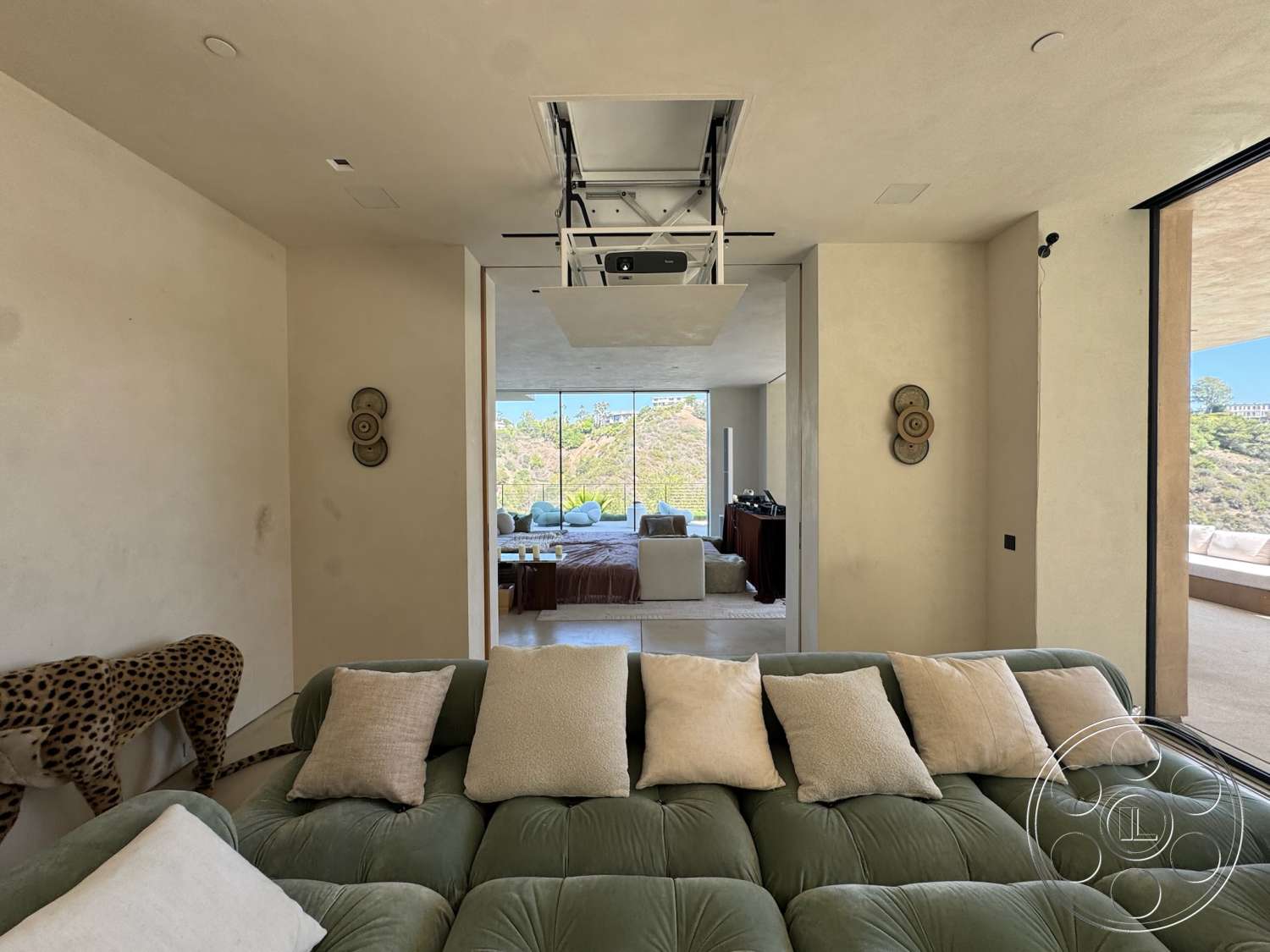 Modern 527 - neutral color palette, natural light, open floor plan, decorative wall art, sliding glass door, modern architectural style, large floor-to-ceiling windows, plaster wall finish, minimalist interior design, smooth ceiling with recessed lighting, view of hillside landscape, green velvet sectional sofa