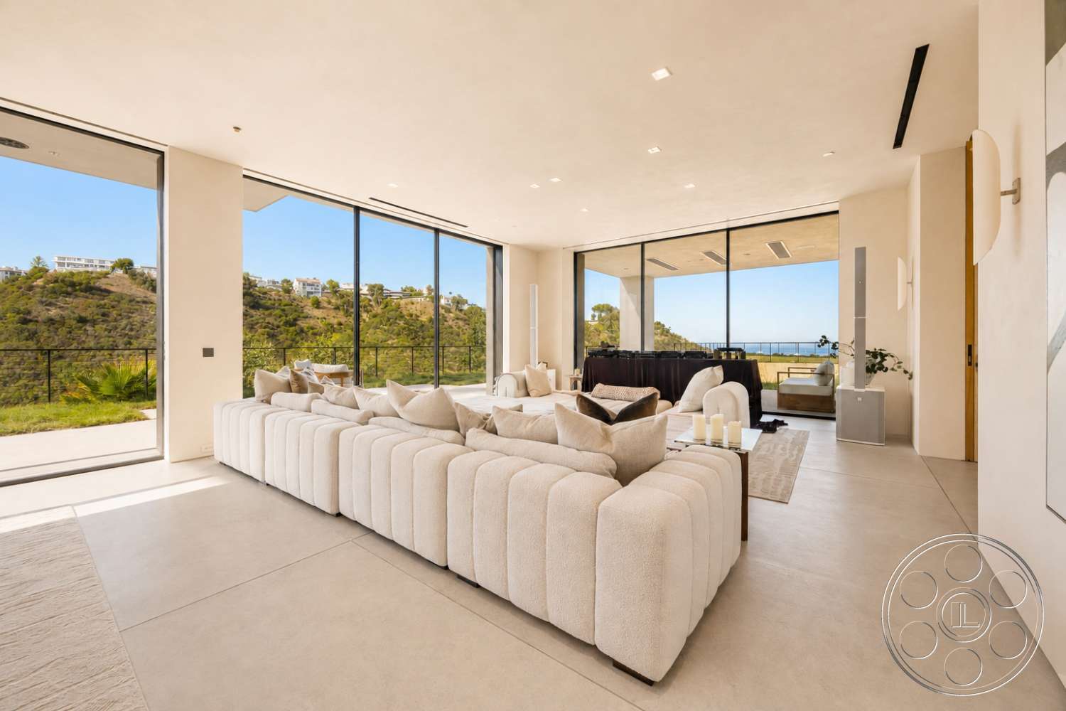 Modern 527 - neutral color palette, natural light, recessed lighting, minimalist design, open floor plan, concrete flooring, sliding glass doors, floor-to-ceiling windows, textured plaster walls, light-toned furnishings, modern sectional sofa, view of hillside landscape, contemporary art features