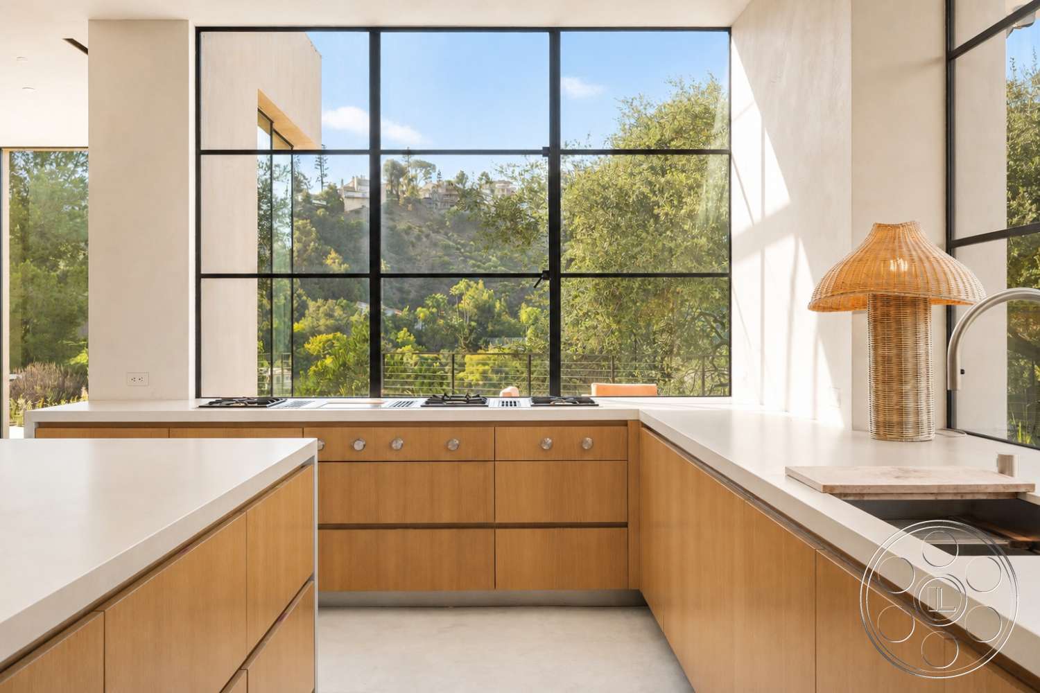 Modern 527 - minimalist aesthetic, wood cabinetry, modern pendant lighting, greenery view, floor-to-ceiling windows, bright and airy space, stainless steel kitchen appliances, rectangular kitchen island, open-concept kitchen design, concrete kitchen countertops, light-colored plaster walls