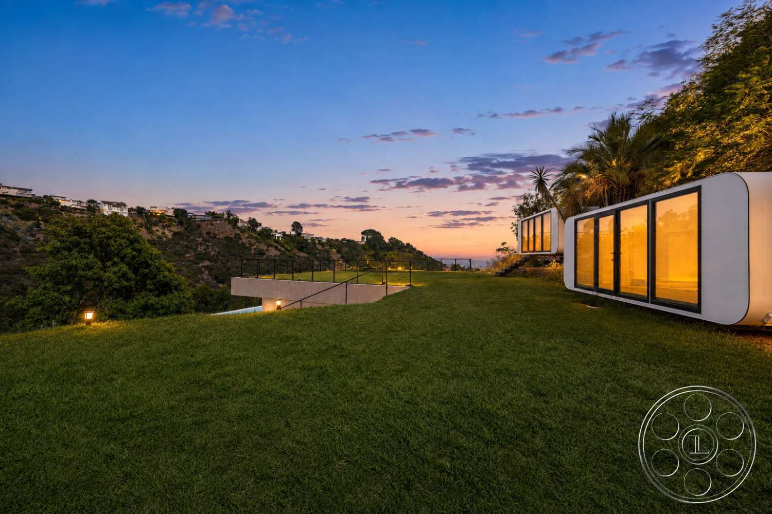 Modern 527 - exterior, natural surroundings, glass windows, grass lawn, outdoor lighting, sunset view, modern architectural style, concrete terrace, landscaped hillside setting, modular glass facade