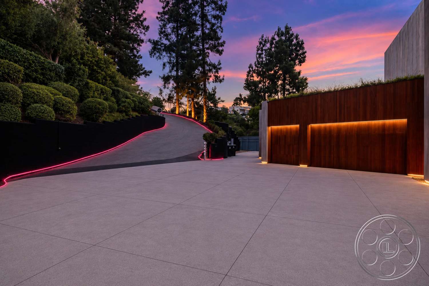 Modern 527 - exterior, modern lighting fixtures, landscaped hillside, concrete driveway, curved driveway, wood accent wall, stone retaining wall, contemporary architectural style, low-maintenance shrubs, urban hillside setting, tile patio flooring, linear landscape lighting, dramatic sunset sky