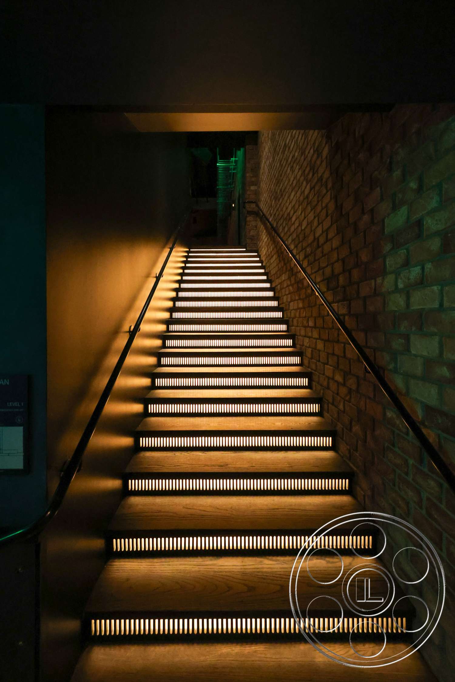 Club 74 - modern design, ambient lighting, exposed brick wall, dark painted walls, steel handrail, wooden staircase with LED accent lighting