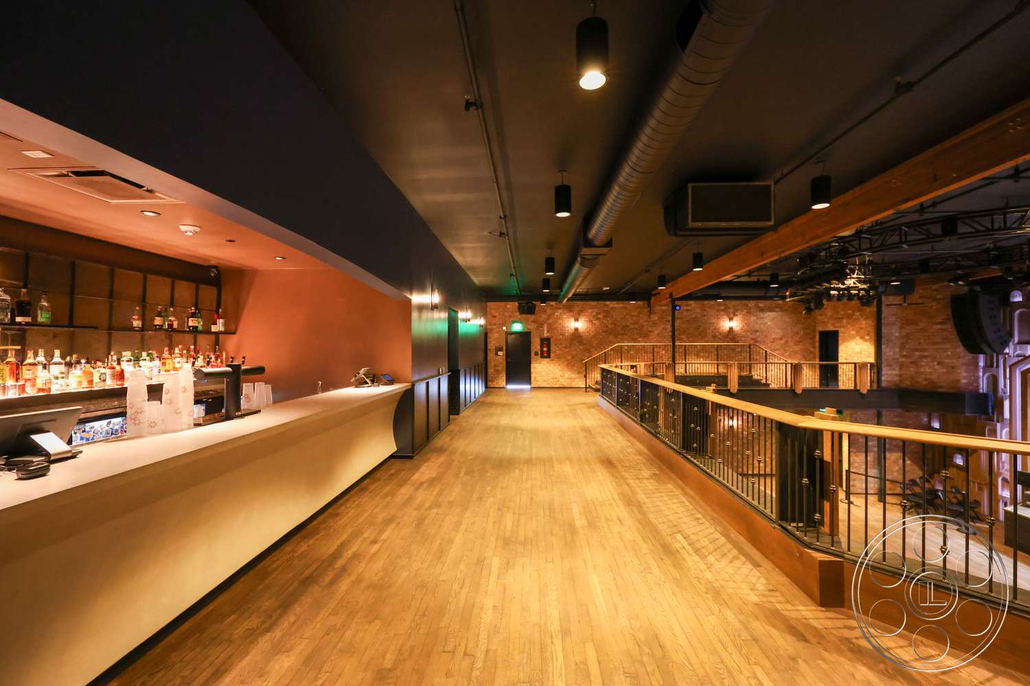 Club 74 - open floor plan, metal railings, exposed brick wall, dark wood flooring, bar counter, wood beam ceiling, industrial style lighting, wooden bar top, cove lighting, painted feature wall, upstairs balcony railings