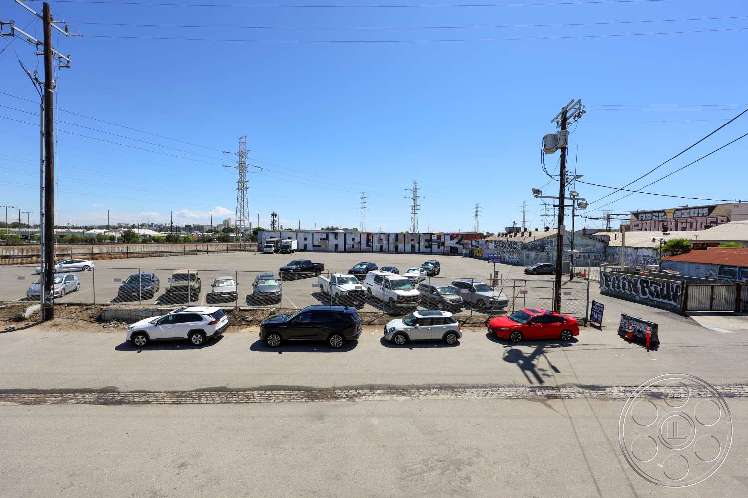 Club 74 - exterior, concrete pavement, urban setting, power lines, chain-link fence, utility poles, asphalt parking lot, commercial buildings, open lot, graffiti wall