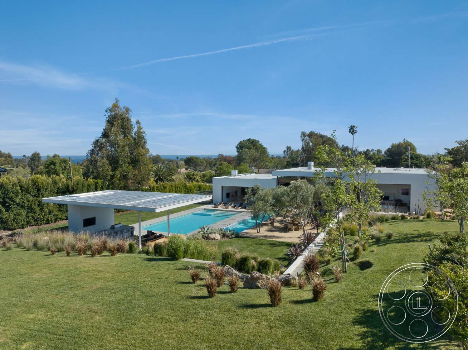 Modern 529 - exterior, modern architecture, rectangular swimming pool, stone pathway, sunlight, grass lawn, ocean view, contemporary home, wooden pergola, concrete pool deck, flat roof design, landscaped garden area, open patio space