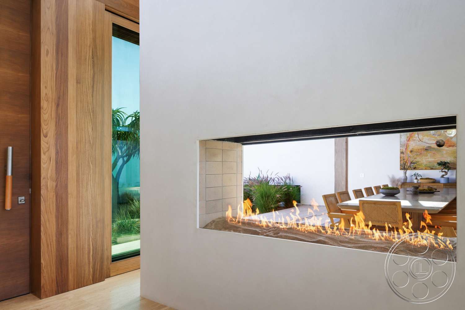 Modern 529 - natural light, indoor plants, light hardwood flooring, exposed concrete wall, natural wood front door, open dining area, modern dining table, woven dining chairs, contemporary architectural style, smooth plaster wall, stainless steel door handle, glass window frame, framed fireplace opening, rectangular fireplace design, minimalist art piece