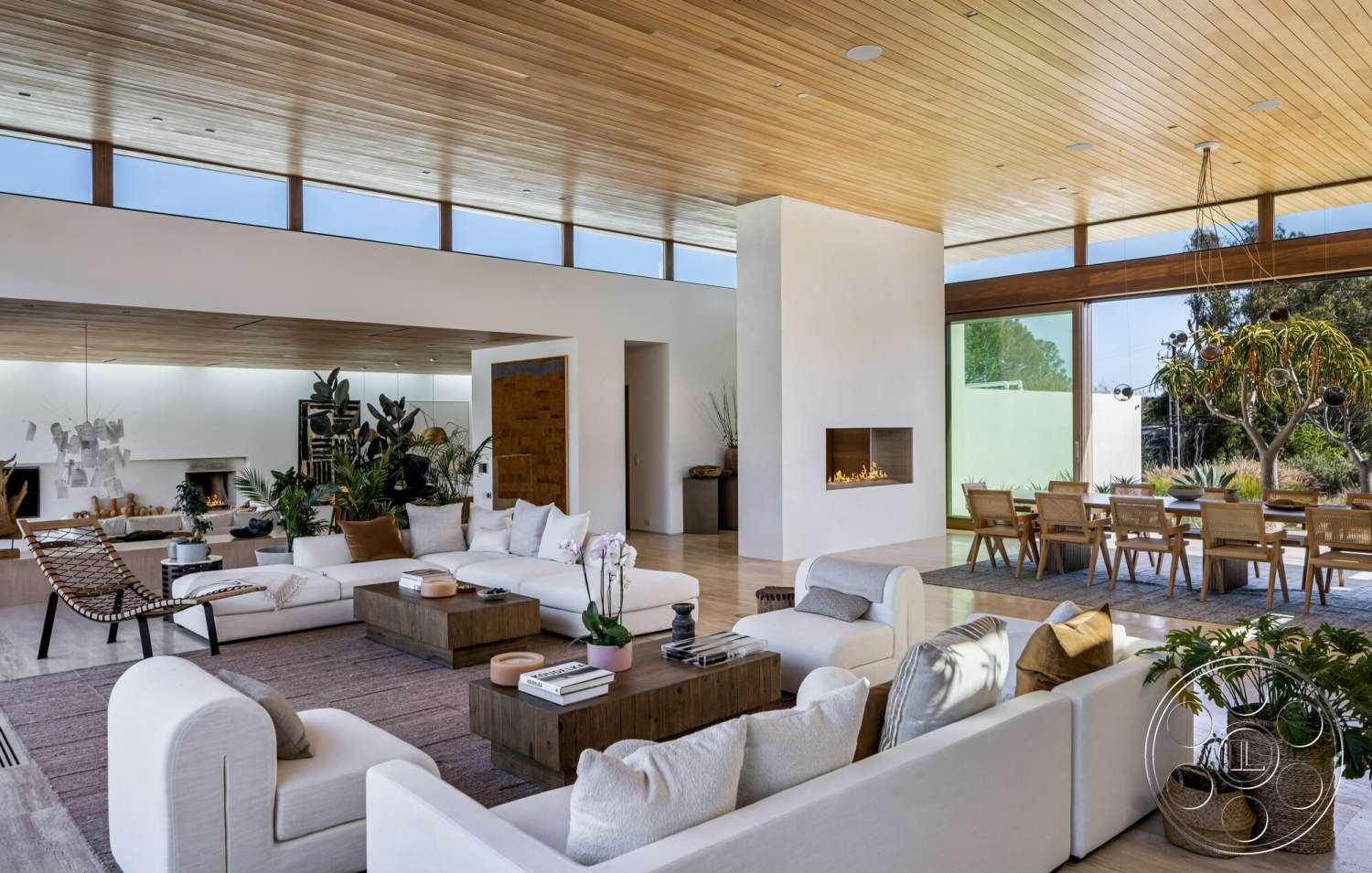 Modern 529 - neutral color palette, large glass sliding doors, textured area rug, light hardwood flooring, artistic wall decor, indoor-outdoor flow, large floor-to-ceiling windows, modern sectional sofa, contemporary dining table, modern architectural design, exposed wood ceiling boards, white wall finish, minimalist fireplace wall, natural wooden coffee table, open-plan living and dining area, dark wood dining chairs, houseplants decor