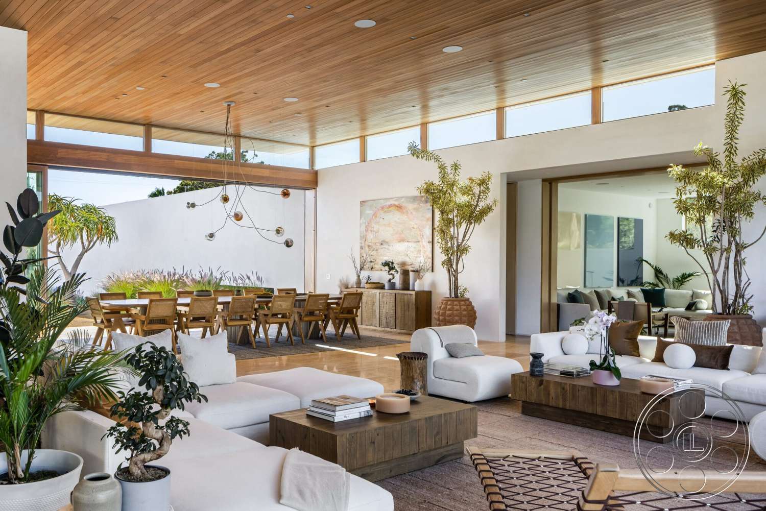 Modern 529 - neutral color palette, natural light, indoor plants, textured area rug, open floor plan, concrete flooring, wood dining table, sliding glass doors, minimalist furniture, floor-to-ceiling windows, wood dining chairs, contemporary art piece, wood beam ceiling, white painted walls, elevated outdoor view, modern pendant lights, accent decor, wood coffee tables