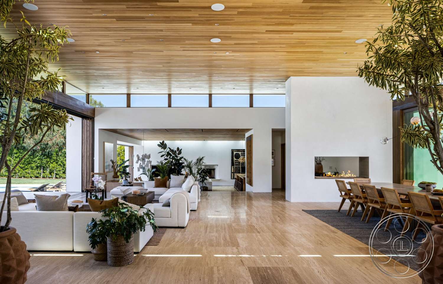 Modern 529 - textured area rug, light hardwood flooring, floor-to-ceiling windows, casual seating arrangement, linear fireplace, contemporary dining area, light wood dining table, wood beam ceiling, modern open layout, white drywall walls, living room plant decor, neutral upholstered sofas