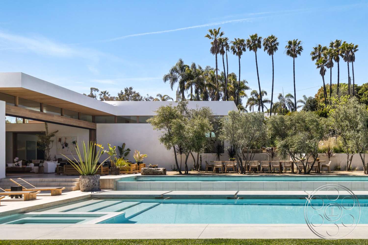Modern 529 - exterior, white stucco walls, sliding glass doors, modern landscaping, floor-to-ceiling windows, outdoor dining area, tropical palm trees, green grass lawn, concrete pool deck, rectangular pool, wooden lounge chairs, flat roof design, concrete patio floor, wood beam overhang, minimalist outdoor seating area, concrete water feature