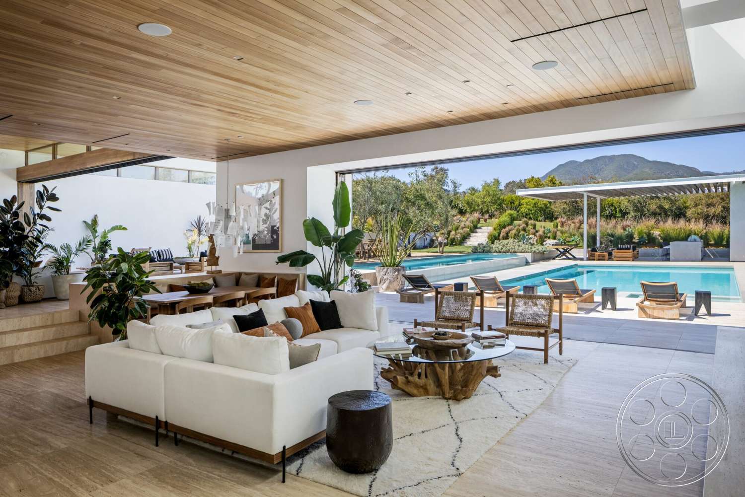 Modern 529 - textured area rug, wood dining table, glass sliding doors, rectangular swimming pool, floor-to-ceiling windows, modern dining area, stone pool deck, mountain view setting, concrete patio flooring, wood beam ceiling, upholstered sectional sofa, tropical indoor plants, light hardwood paneling, decorative glass pendant lights