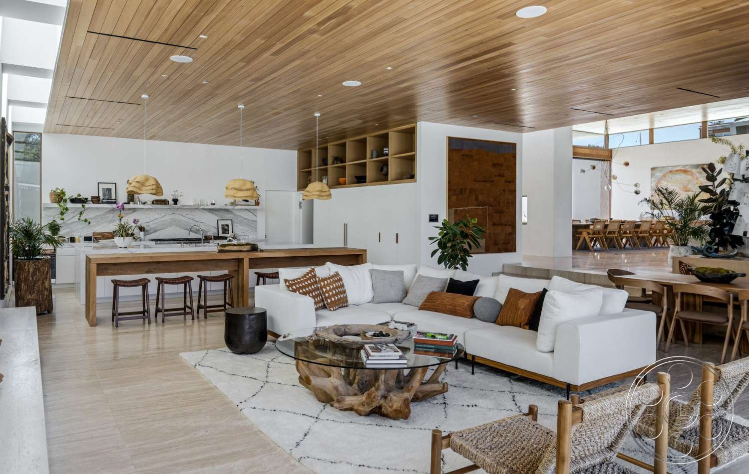 Modern 529 - neutral color palette, large windows, textured area rug, natural wood cabinetry, concrete floor, glass coffee table, wood dining table, contemporary lighting fixtures, upholstered sofa, open-concept living area, wood beam ceiling, marble kitchen backsplash, potted indoor plants, modern accent chairs, exposed wood wall art, cowhide throw pillows