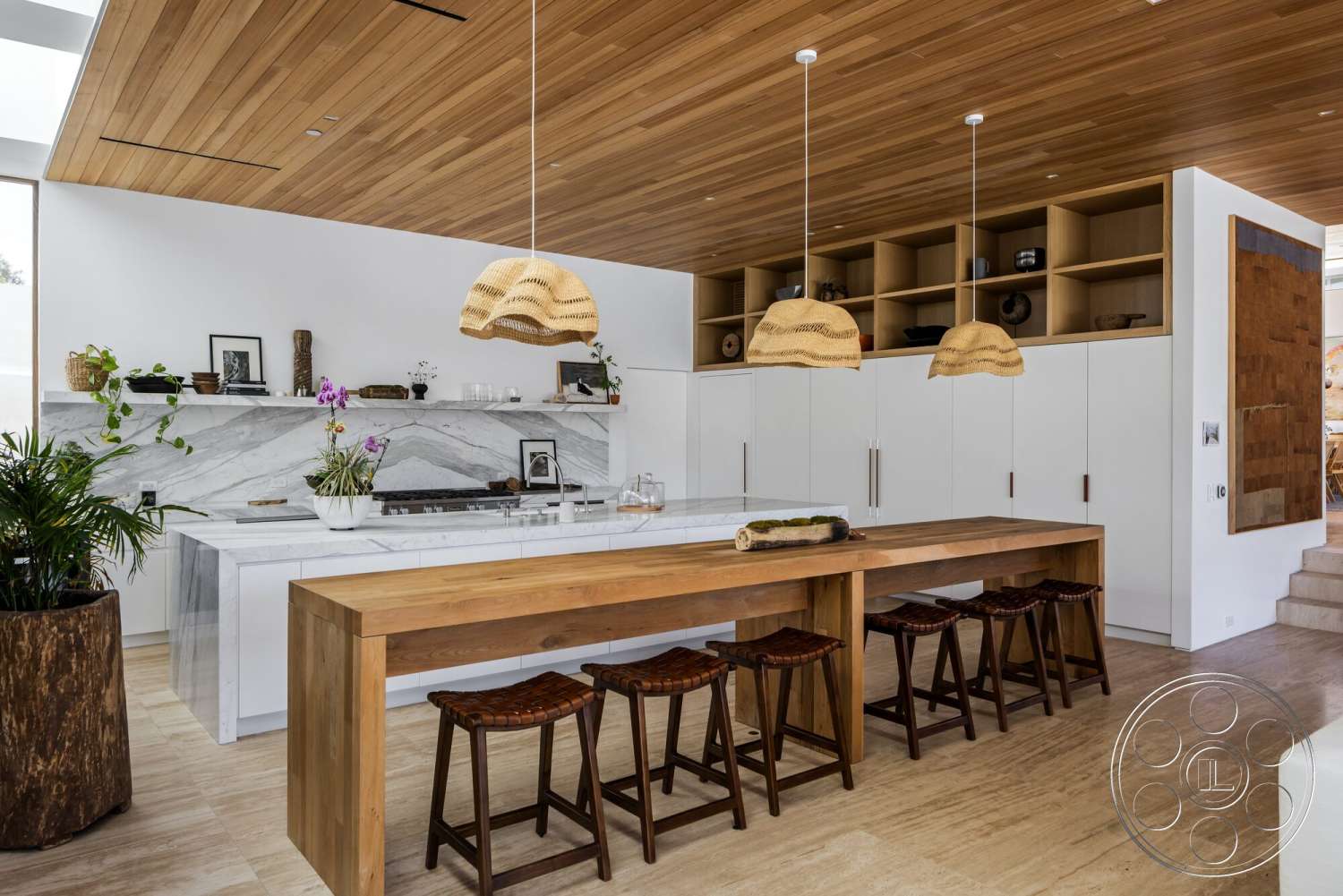Modern 529 - open shelving, wood dining table, exposed wooden beams, white cabinetry, green plant decor, natural stone flooring, woven pendant lights, marble kitchen countertop, marble kitchen backsplash, wood ceiling paneling