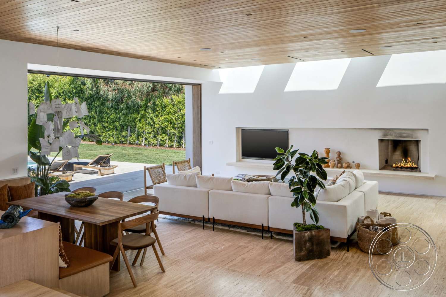 Modern 529 - minimalist decor, neutral color palette, contemporary style, indoor plants, large glass sliding doors, floor-to-ceiling windows, textured plaster walls, light wood dining table, wide open layout, bamboo flooring, natural light-filled space, stone fireplace surround, upholstered sectional sofa, wood ceiling planks, modern pendant light