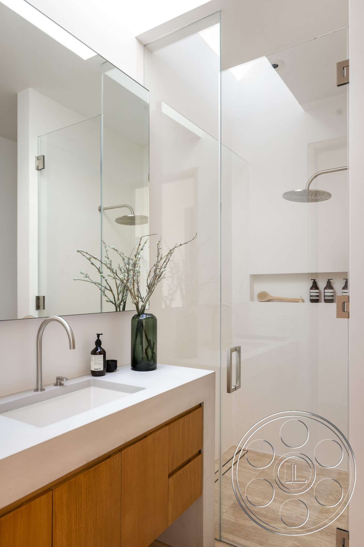Modern 529 - minimalist decor, recessed lighting, glass shower enclosure, mirrored wall, white quartz countertop, built-in shower niche, modern bathroom design, open shower design, wood bathroom vanity, polished stone bathroom flooring, angled skylight