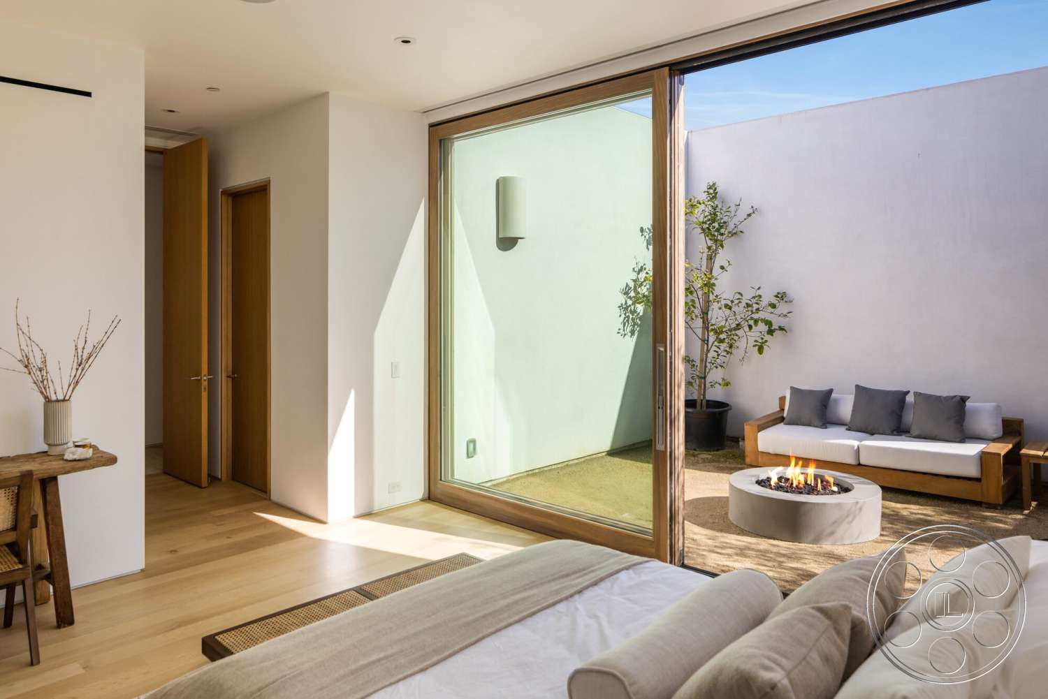 Modern 529 - contemporary design, minimalist aesthetic, floor-to-ceiling windows, natural light-filled space, hardwood bedroom floors, white painted walls, modern outdoor seating area, concrete fire pit, built-in wooden furniture, open courtyard view