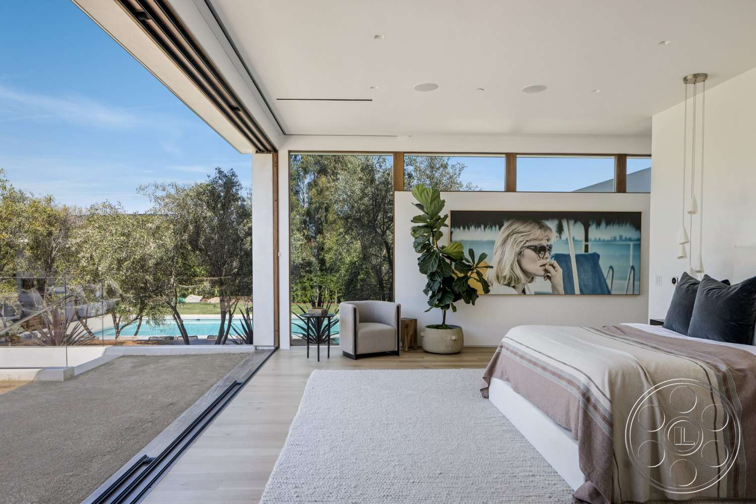 Modern 529 - sliding glass doors, outdoor landscaping, pool view, linear pendant lighting, plush area rug, small dining table, contemporary art piece, minimalist wall treatment, white painted walls, open layout design, floor-to-ceiling glass windows, natural light emphasis, indoor potted plant, modern bed frame, decorative throw blanket, functional seating area, light hardwood bedroom floors